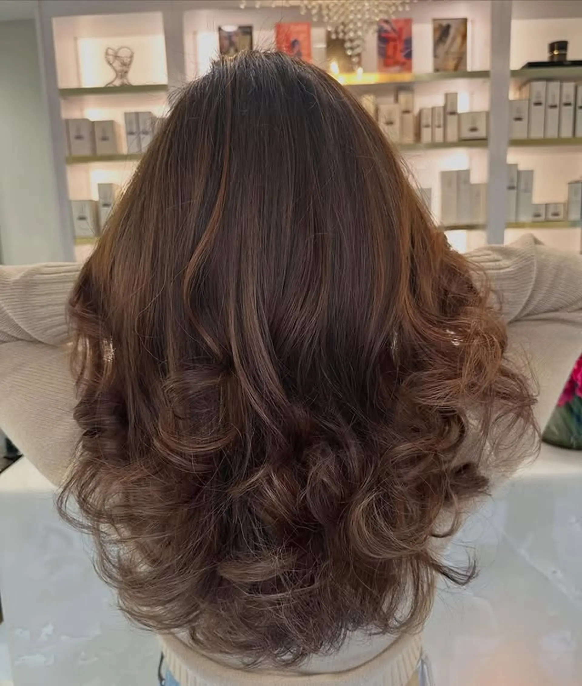 A long, wavy hairstyle with soft curls. 1