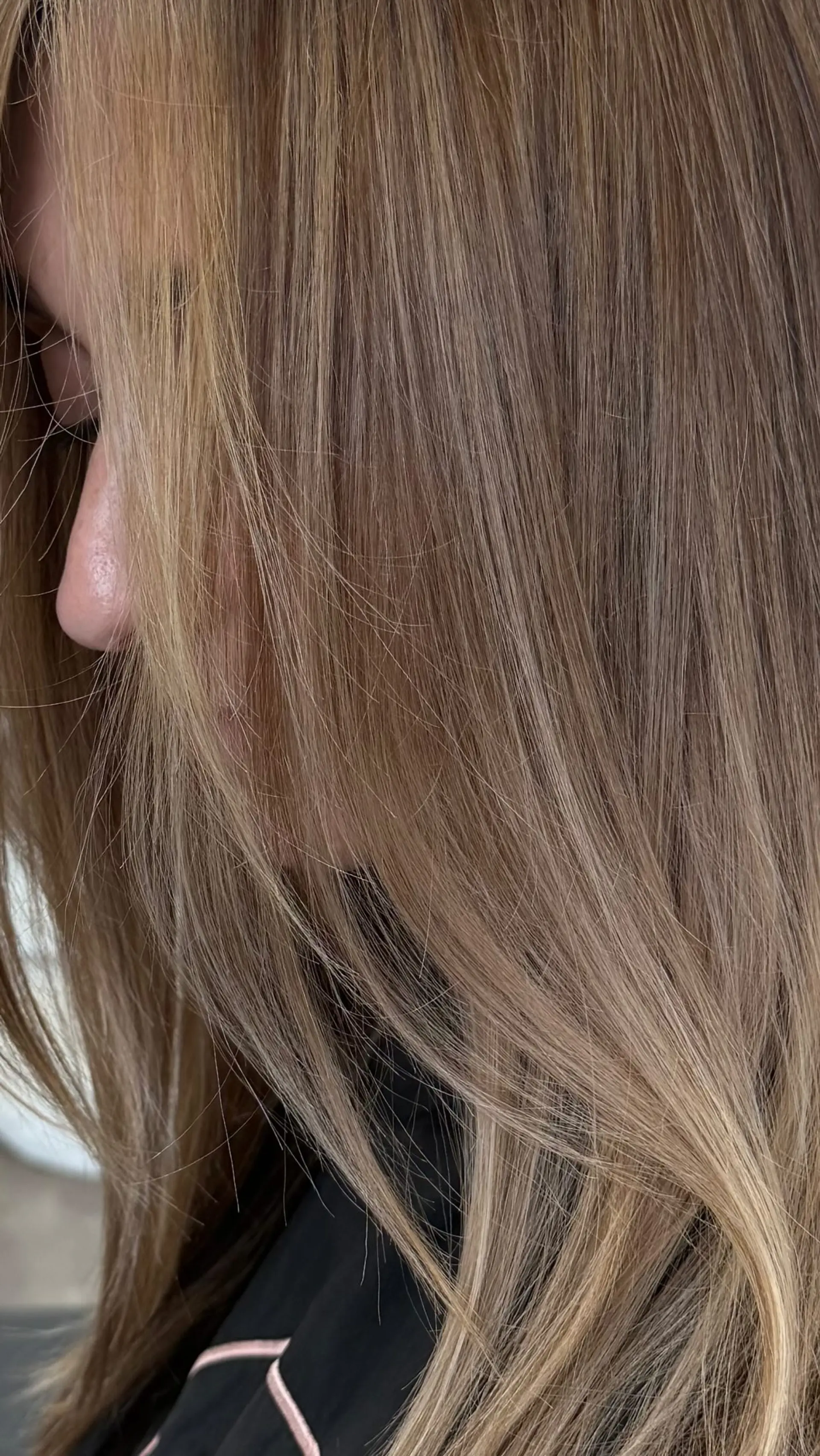 Smooth, straight hair showcasing a delicate blend of cool ash and soft beige blonde tones over a neutral light brown base. 1