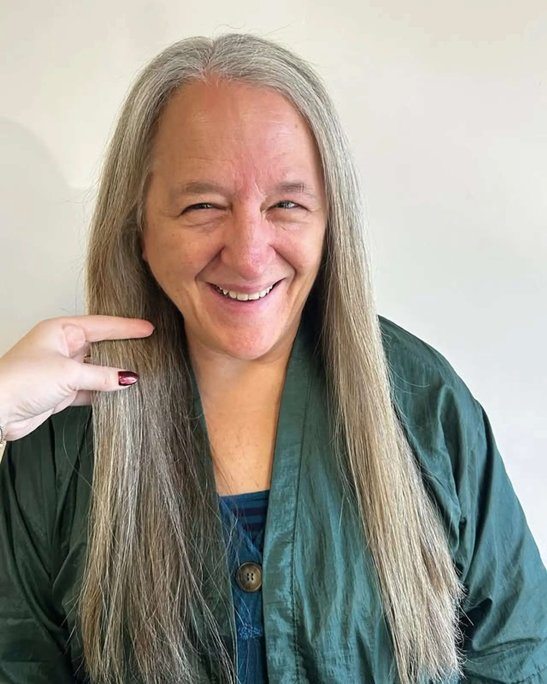 A waterfall of straight, silver and gray hair cascading down the shoulders. 1