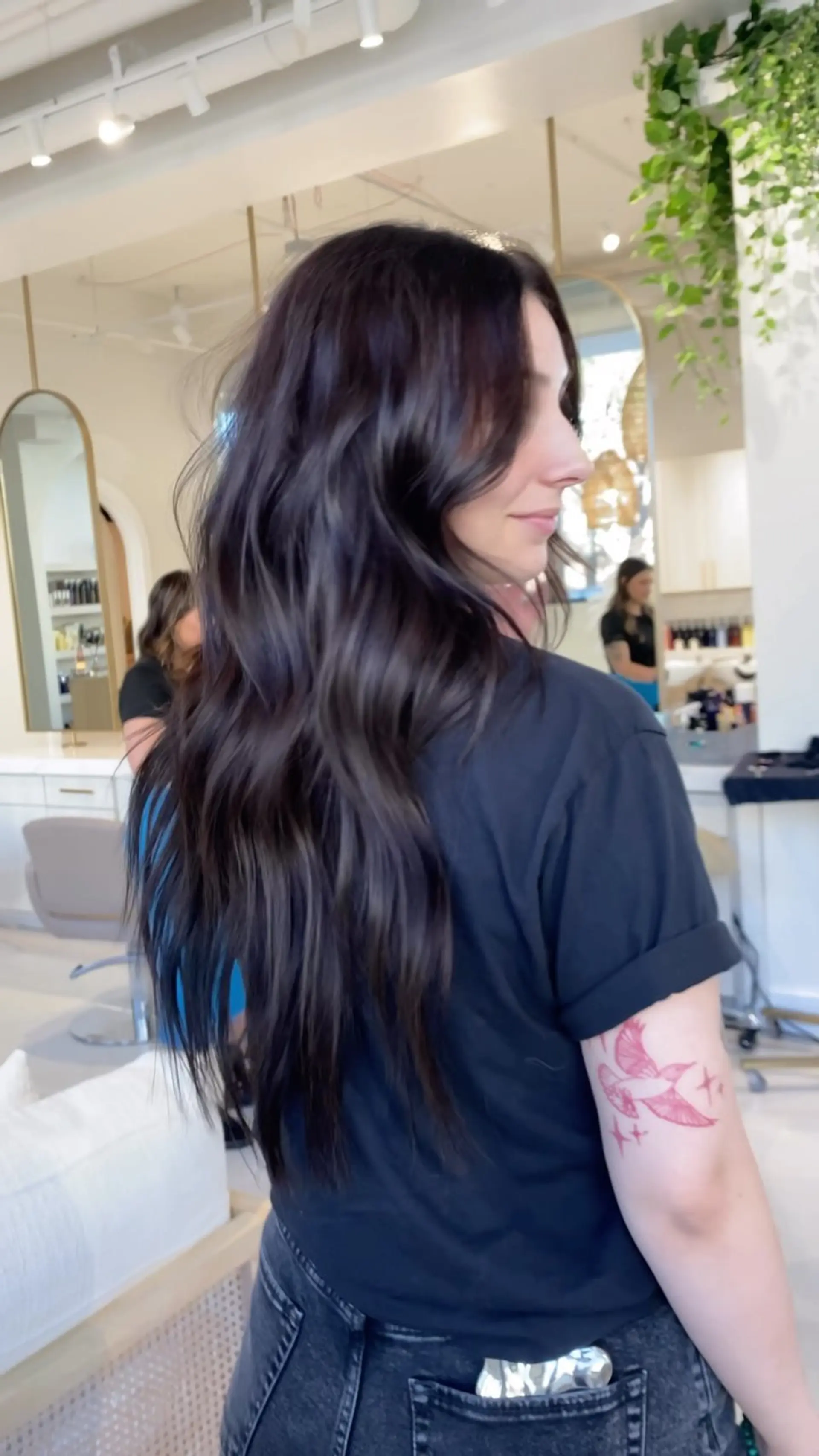 Long, rich dark brown hair styled with loose, effortless waves and natural movement. 1