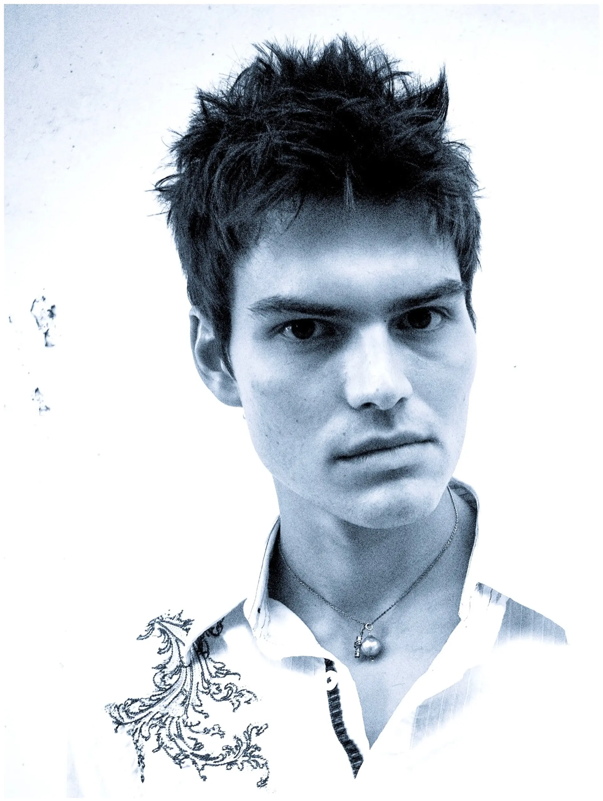 A short, piecey haircut styled in textured, upward spikes. 1