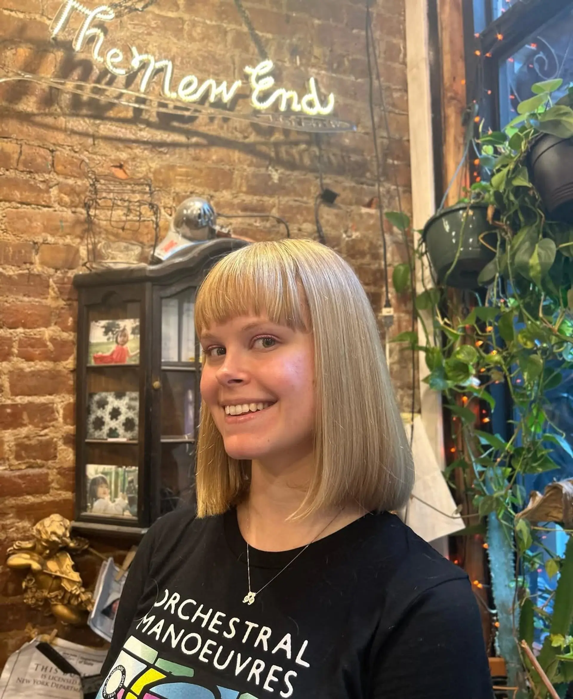 A sleek, blunt bob with straight bangs, providing a modern and chic look. 1