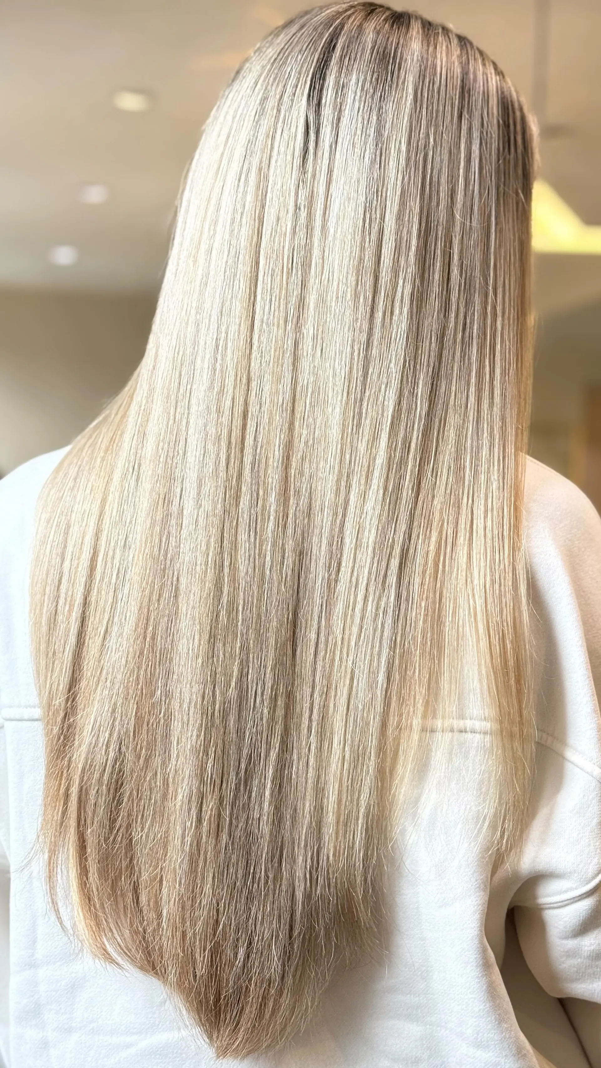 Ultra-long, sleek straight blonde hair with bright, fine foil highlights and a smooth, glossy finish. 1