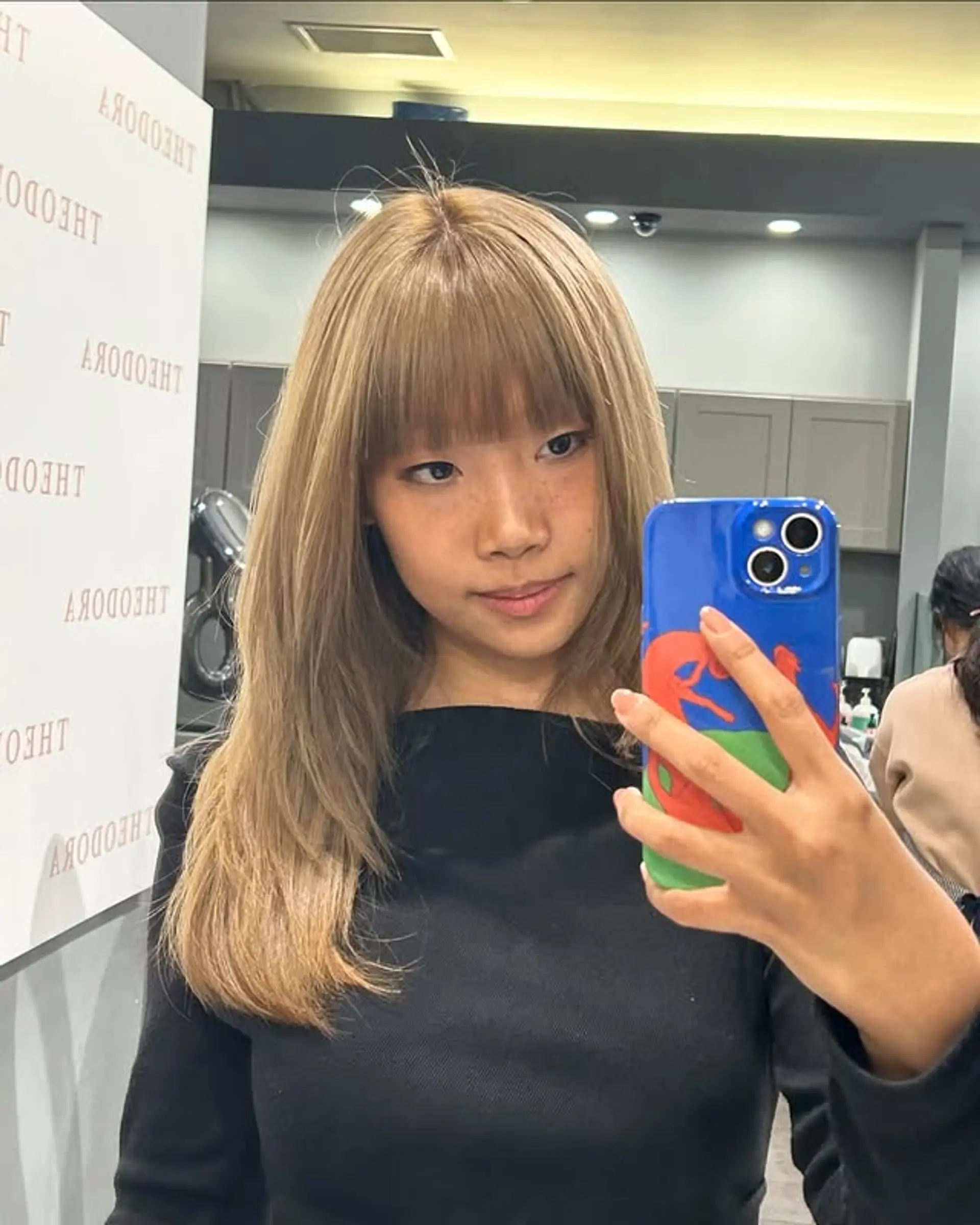 This hairstyle features a medium-length shag with a full fringe of blunt bangs and layers. 1