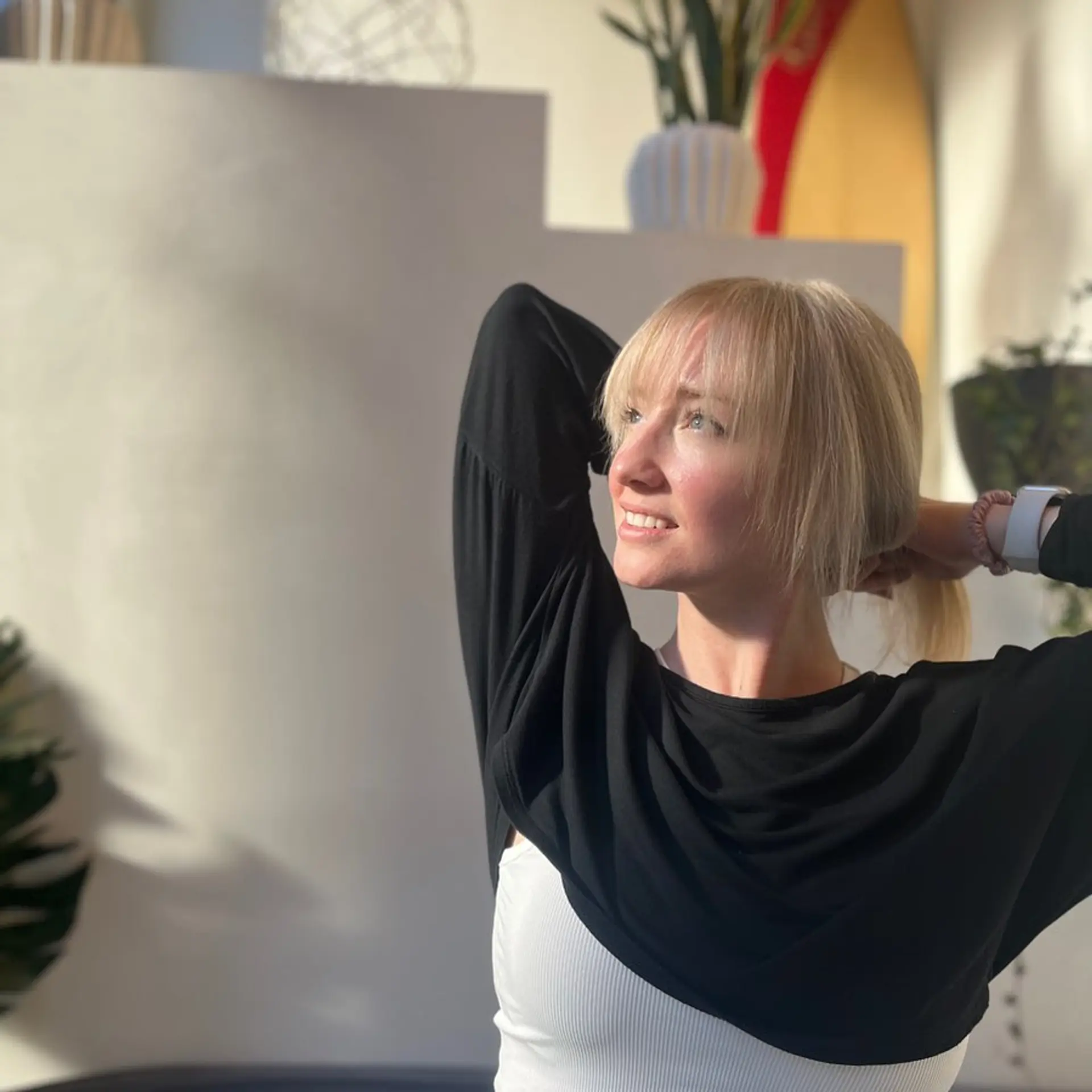 Medium-length, straight, blonde hairstyle with straight bangs resting above the eyebrows, smooth and sleek texture.  1