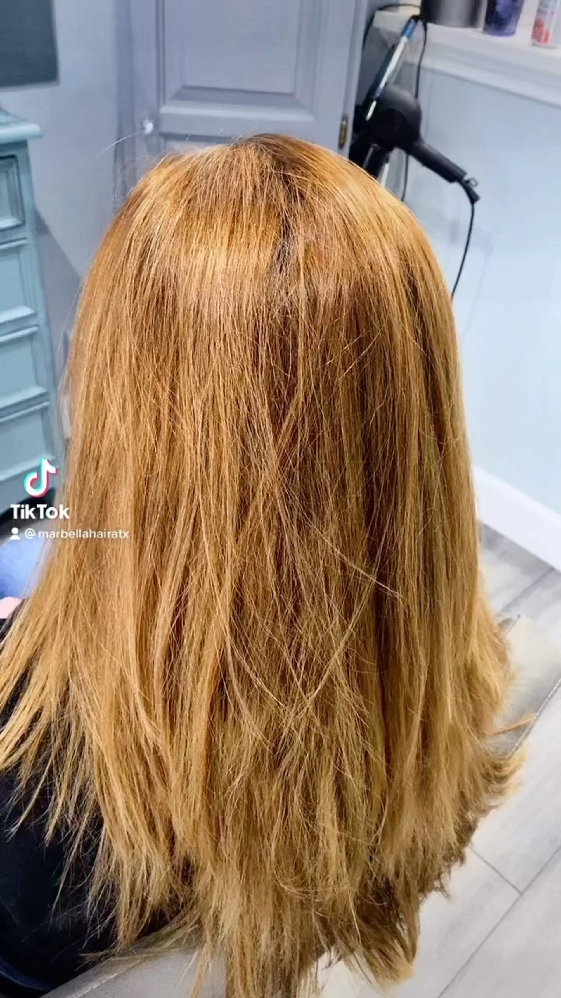 Medium-length warm cinnamon auburn hair styled straight with light natural texture and layered ends. 1