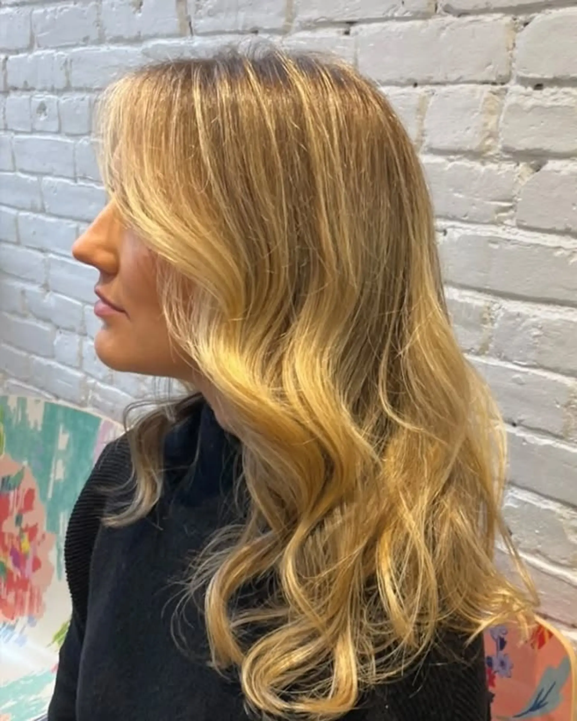 A wavy medium-length style with face-framing curtain bangs. 1