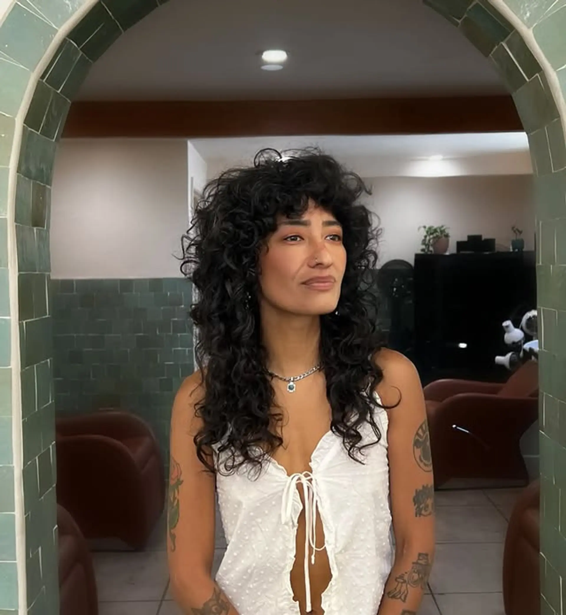 A shag haircut with lots of natural volume, textured layers and fringed curly bangs. 1