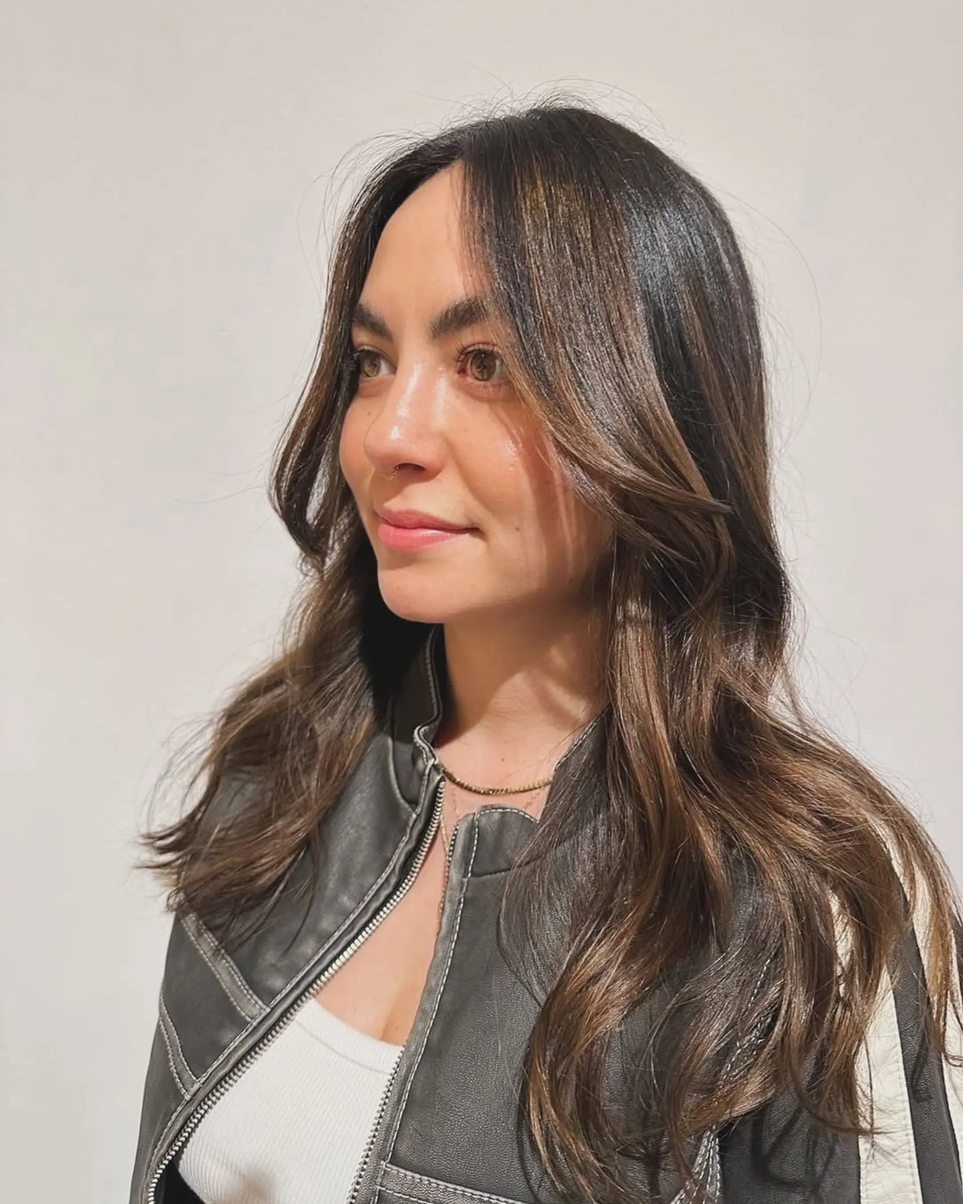 Long layered waves with subtle bronze highlights. 1