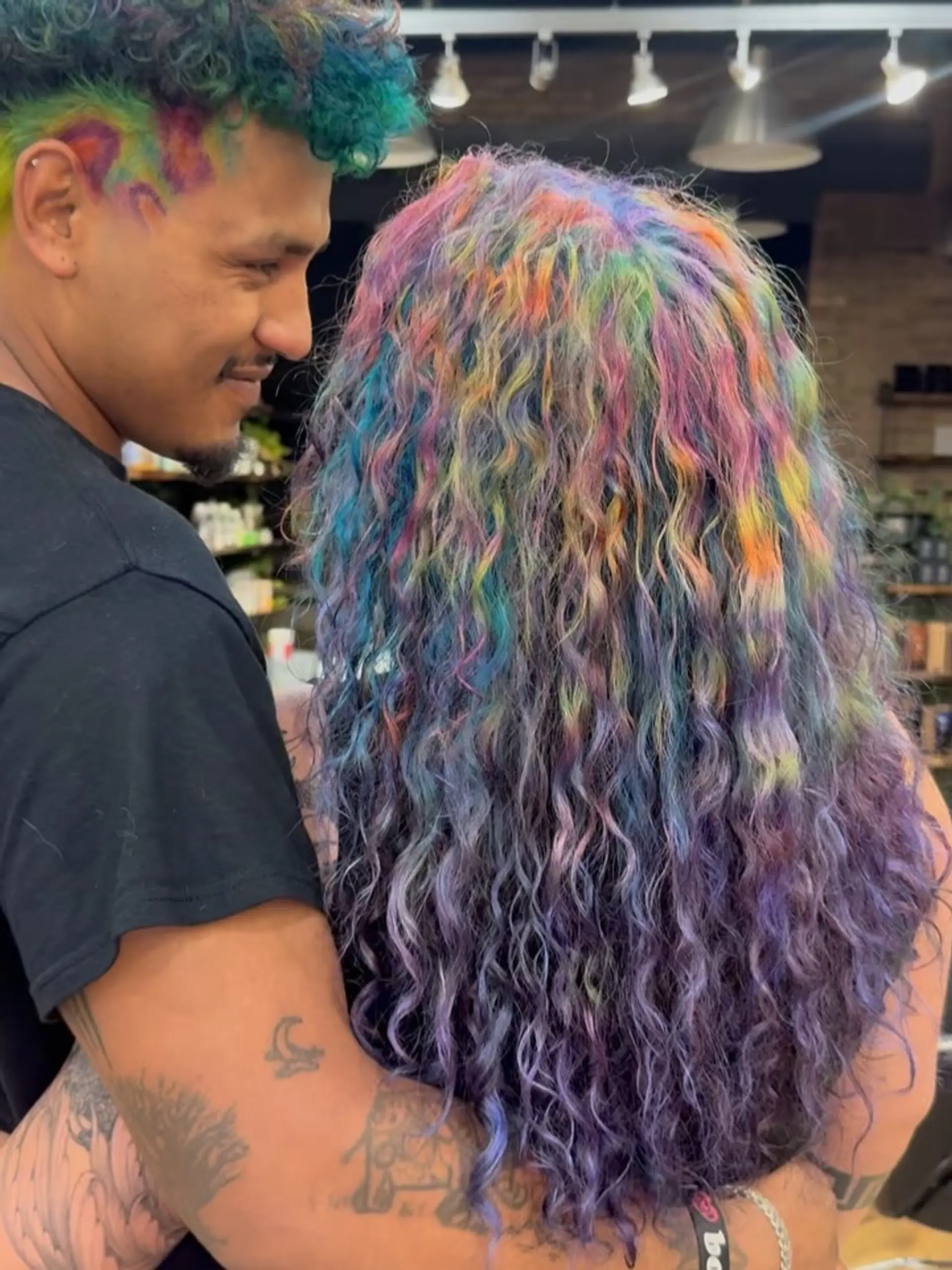 Long defined curls showcasing an intricate, multi-tonal blend of vivid rainbow shades. 1