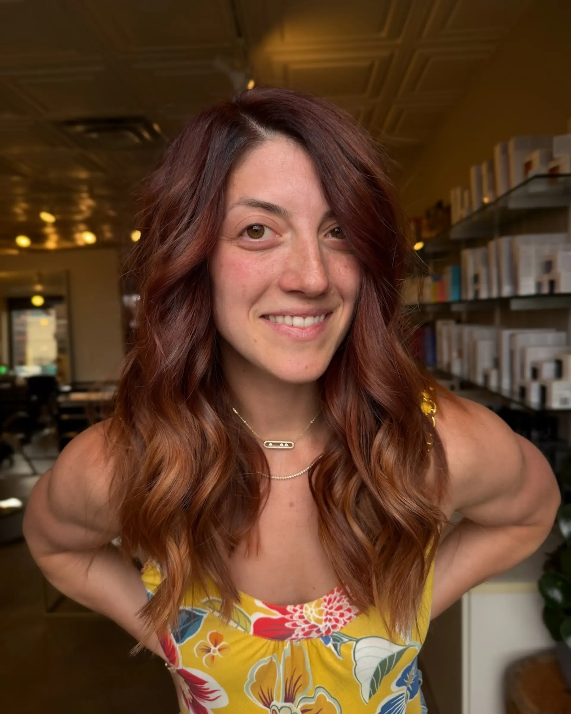 Long dimensional auburn and copper hair styled in loose, textured waves with a side part. 1