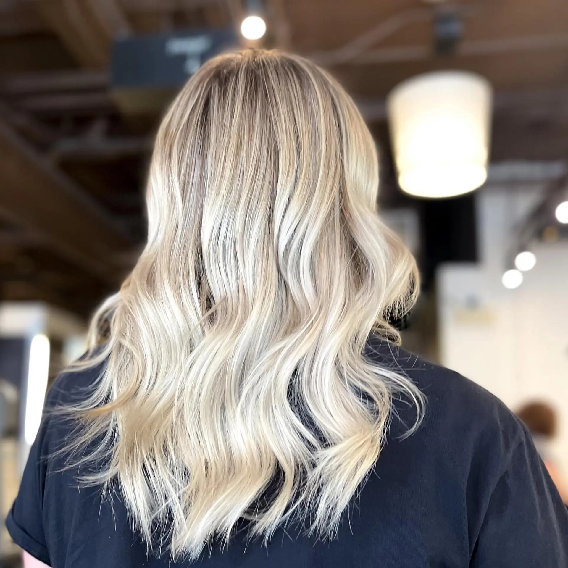 Long, wavy hair with dimensional blonde highlights creating a beach wave effect. 1