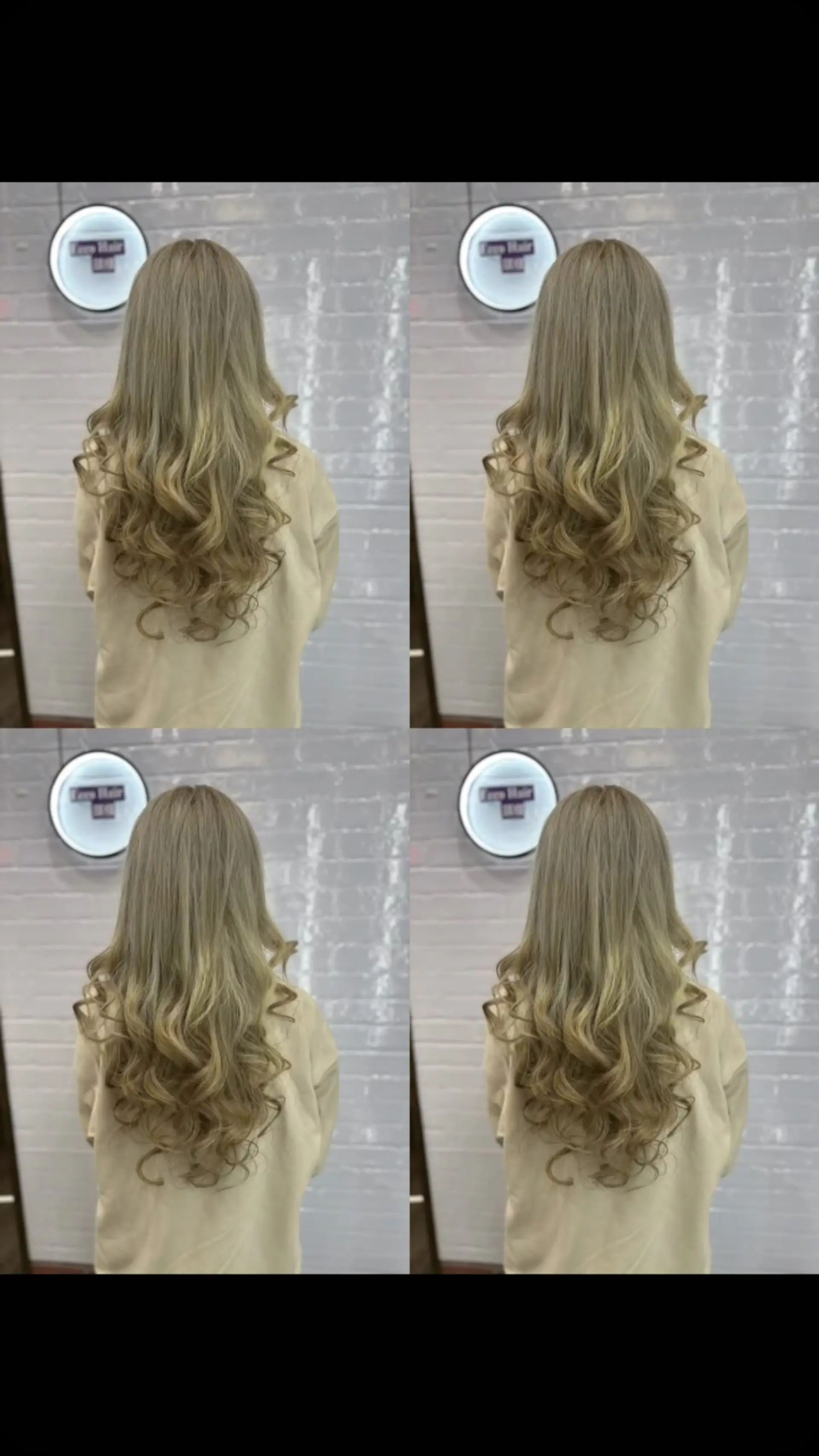 Long ash blonde layered hair styled with defined, voluminous curls through the mid-lengths and ends. 1