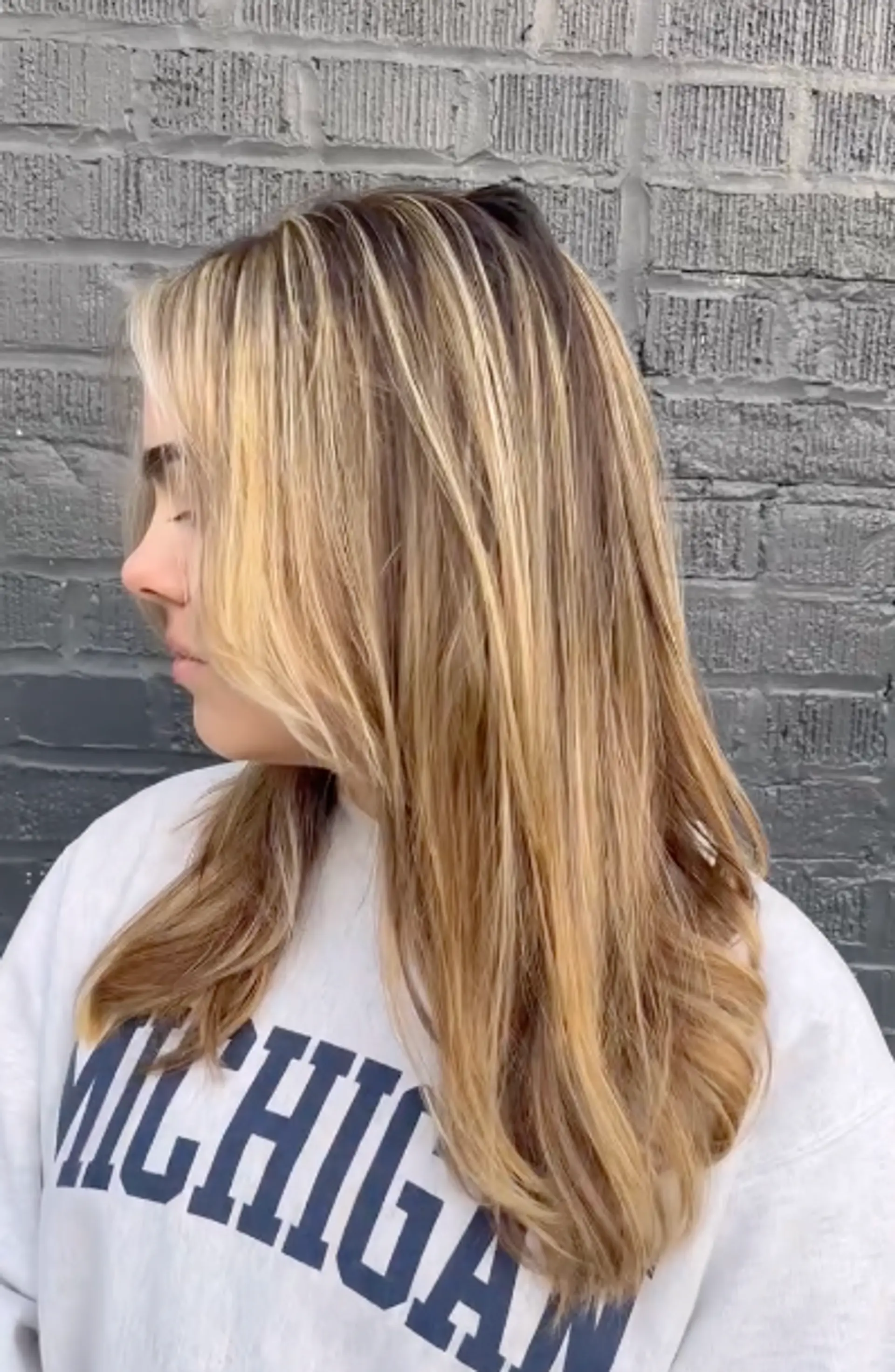 Medium-length straight hair with a blend of blonde and brown shades, featuring natural highlights and a side part. 1