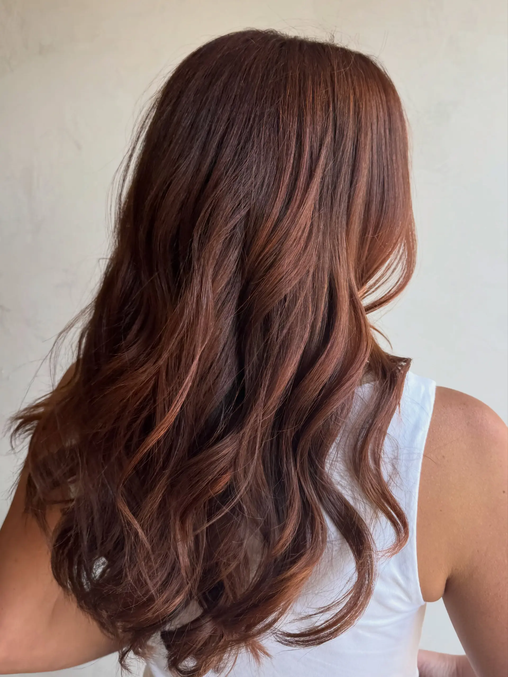 Long, rich cinnamon copper hair styled with soft, loose waves cascading down the back. 1