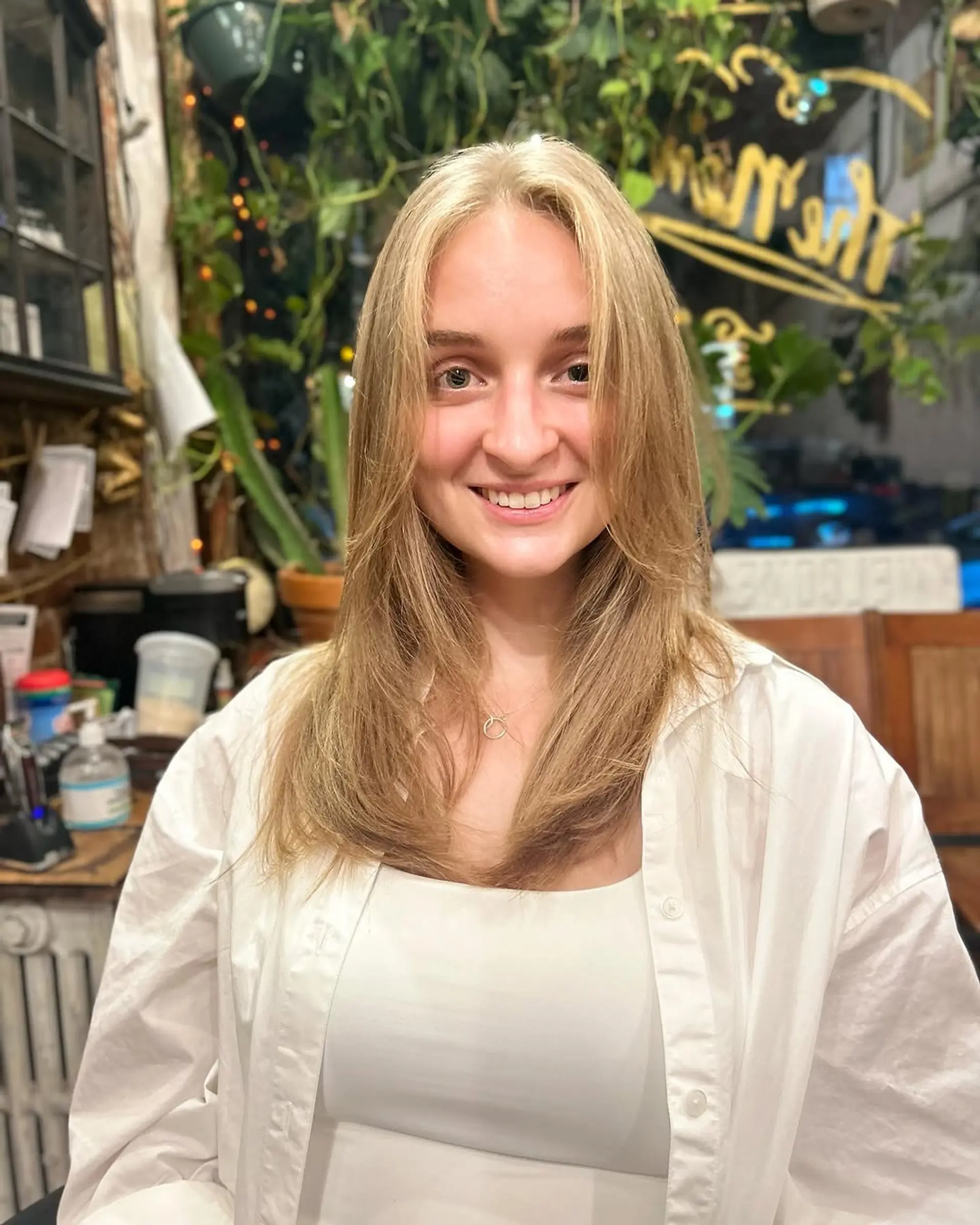 A long, layered hairstyle with face-framing layers. 1