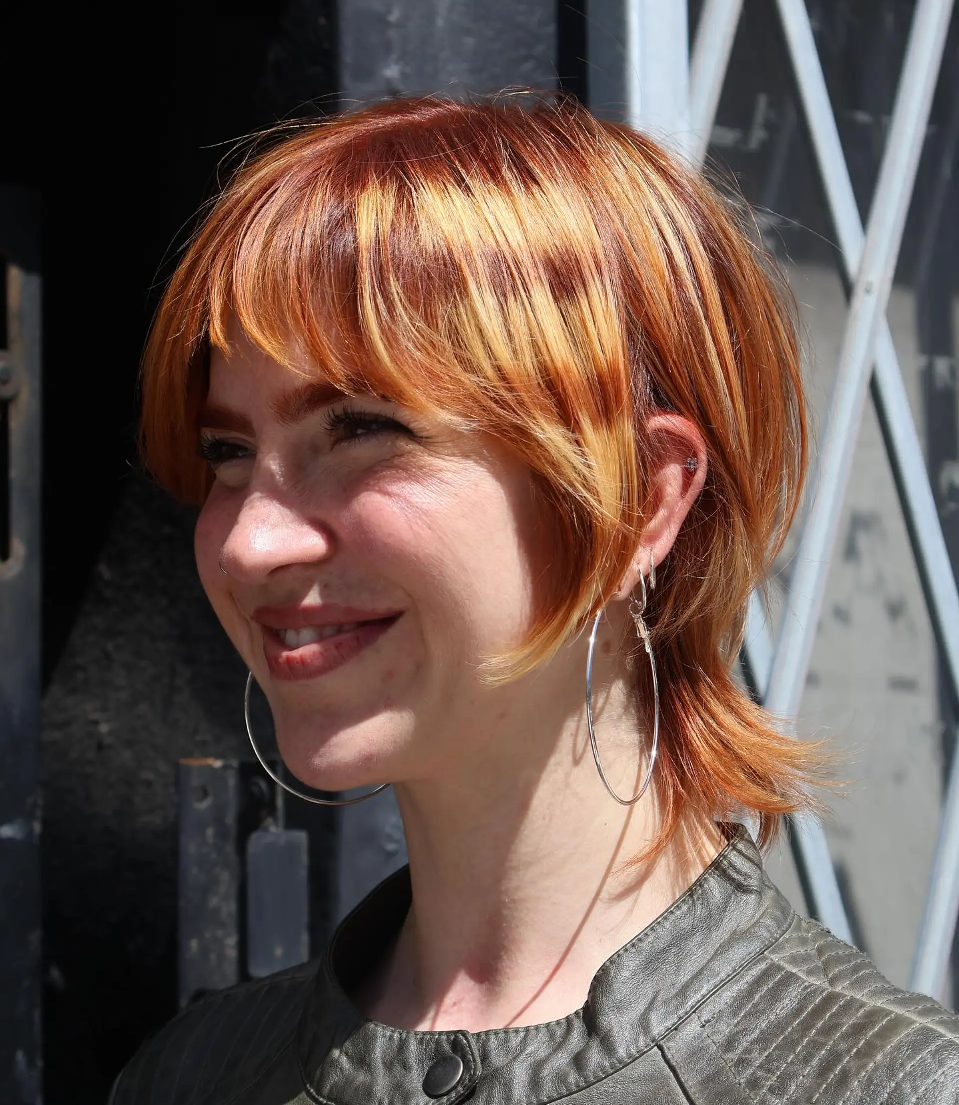 A short,  pixie cut with choppy bangs and layered sides. 1