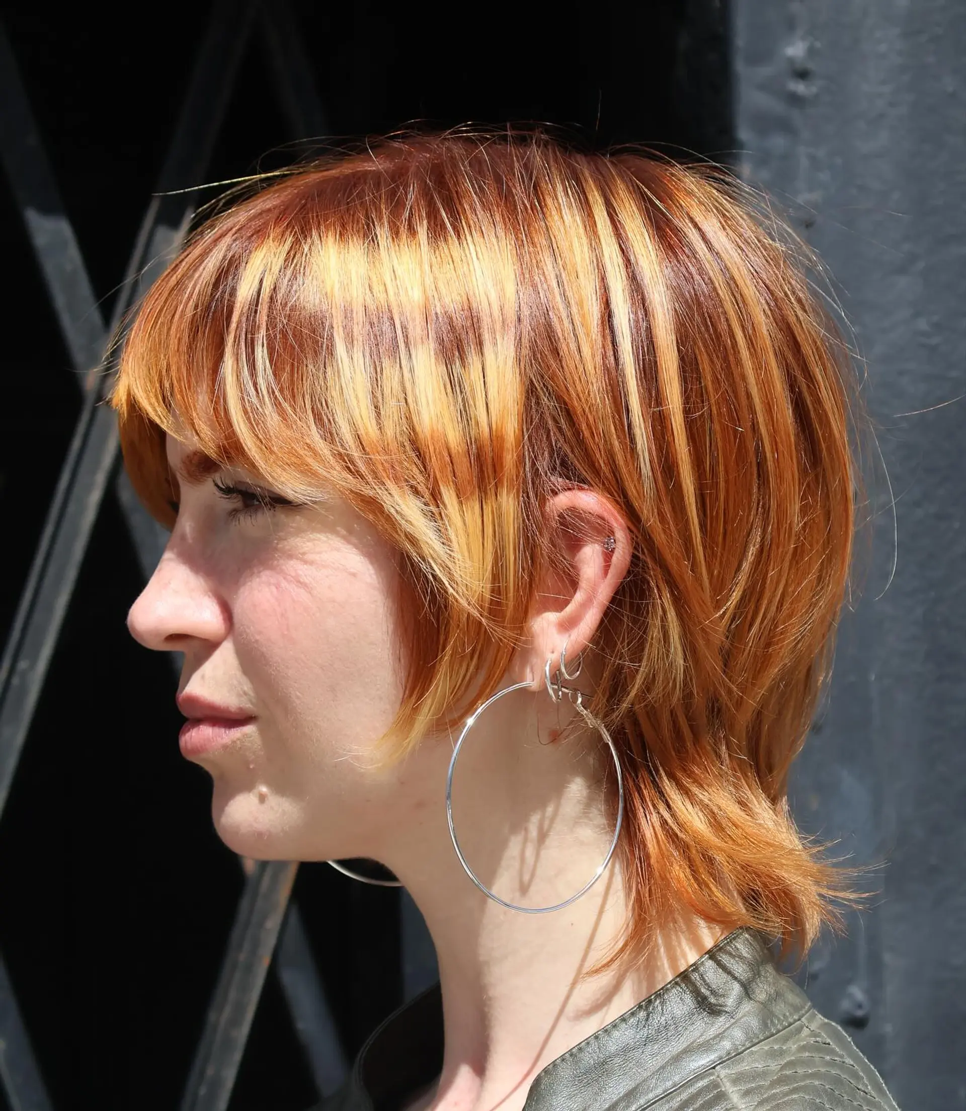 A short,  pixie cut with choppy bangs and layered sides. 2