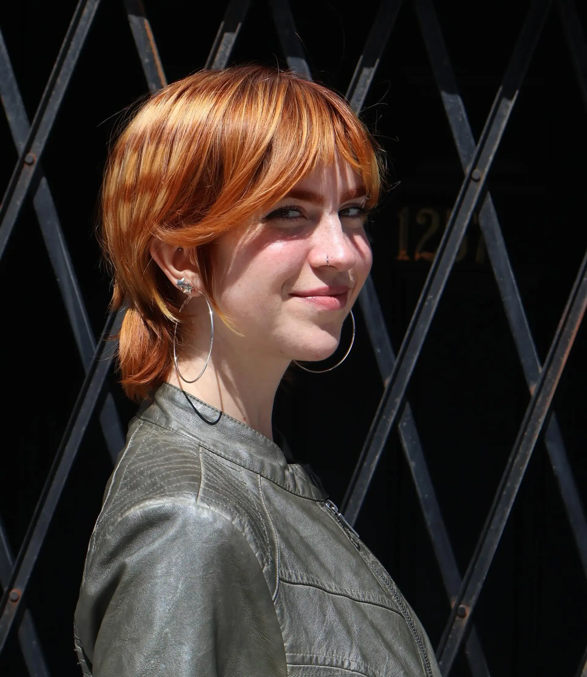 A short,  pixie cut with choppy bangs and layered sides. 4