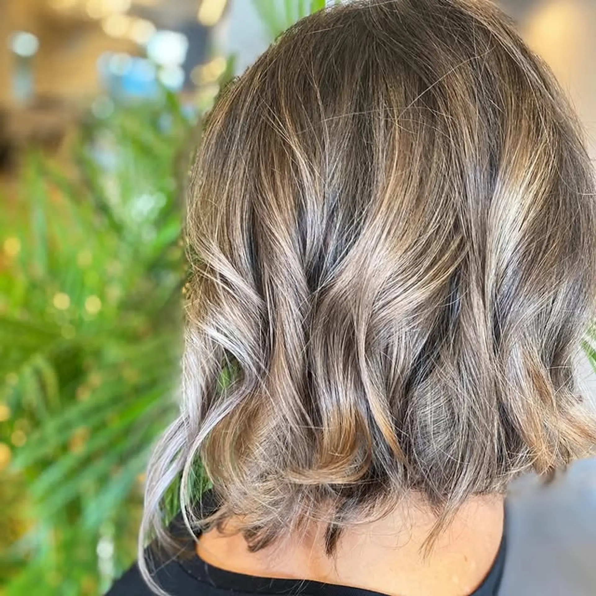 A layered bob with a soft, wavy texture and a blended bronde color. 1