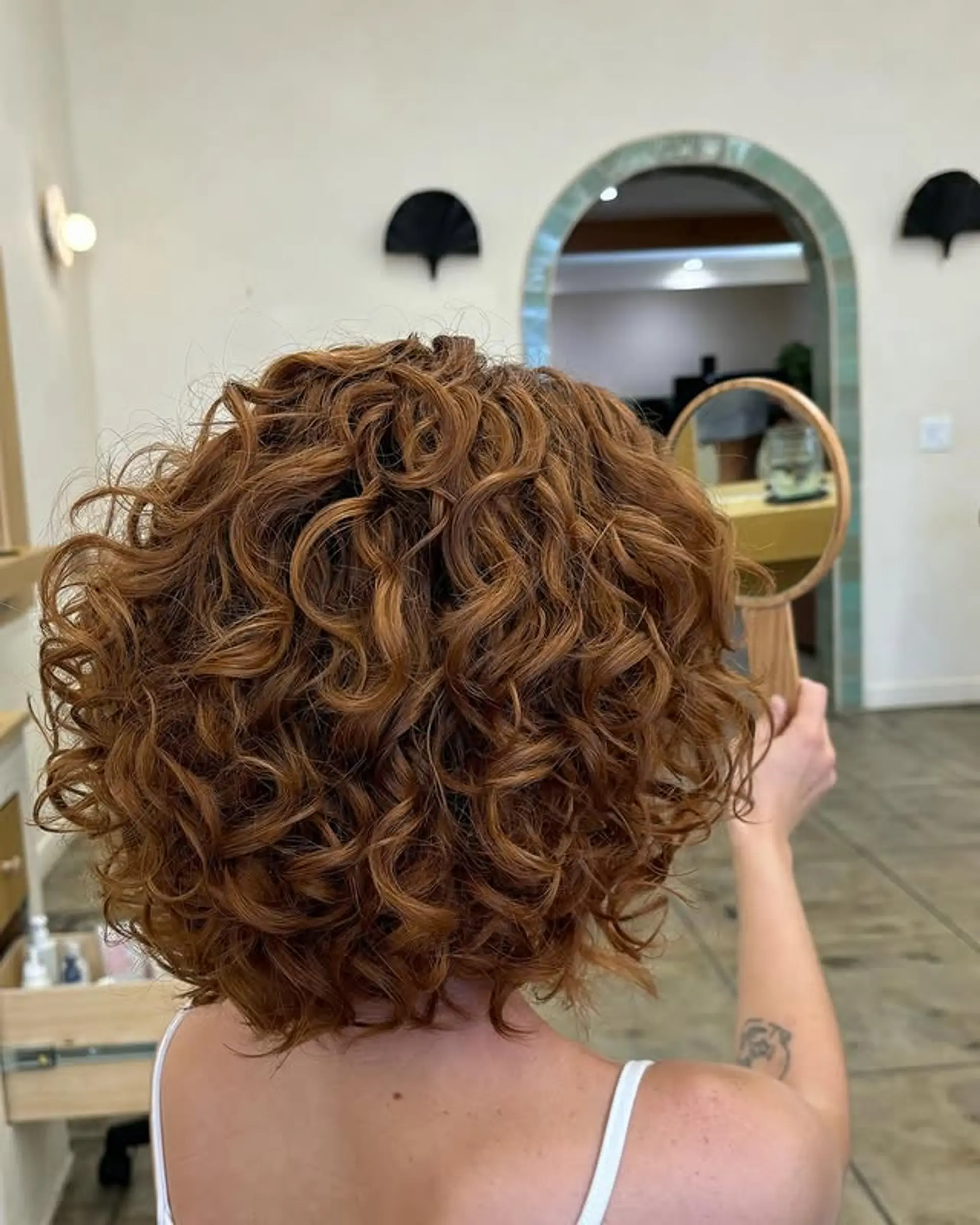 A curly bob with defined curls and a voluminous shape. 1
