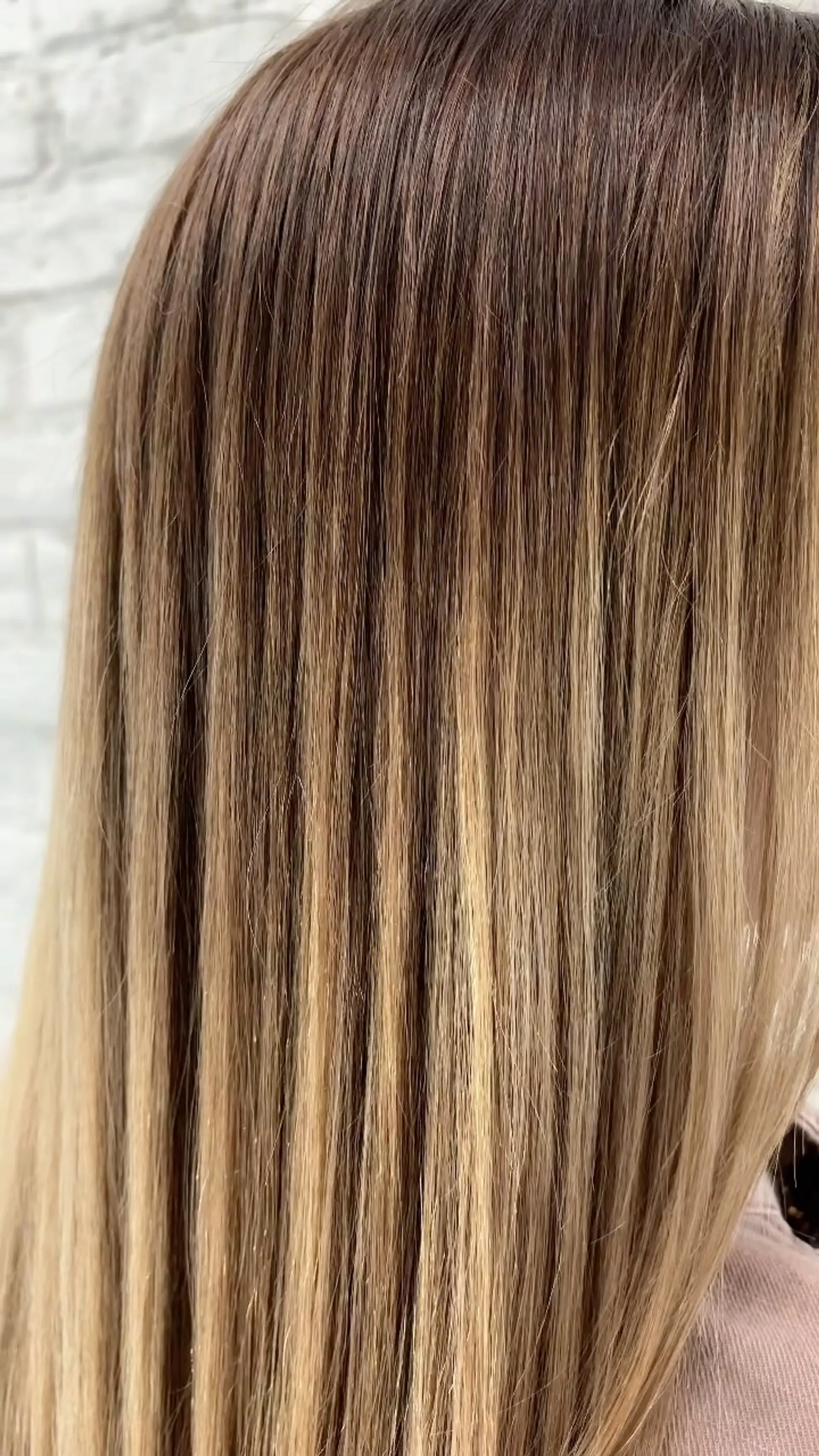 Straight, silky hair styled with seamless natural blonde highlights blended into a soft brown base. 1