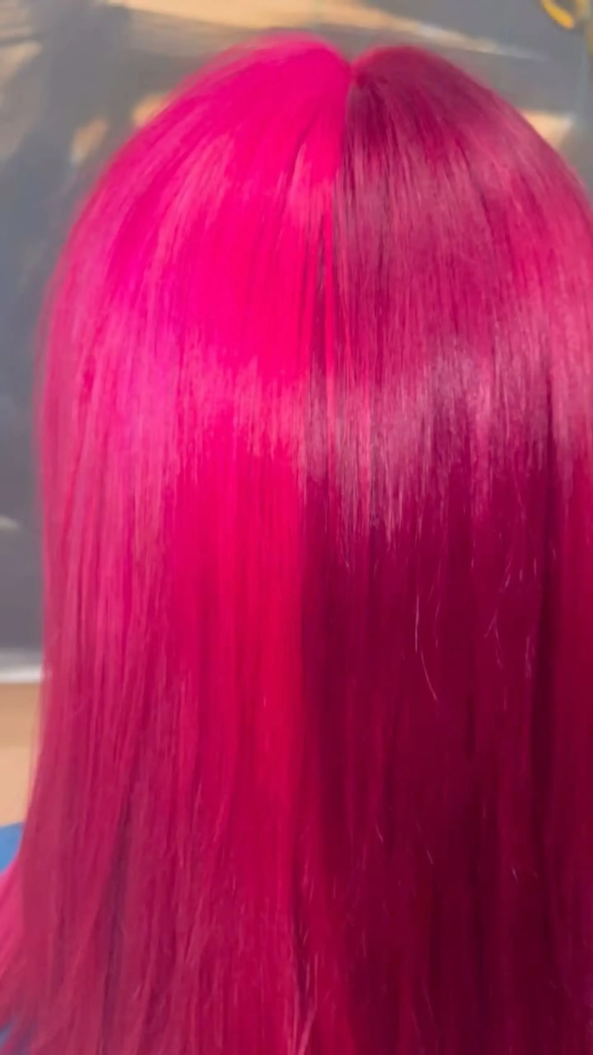 Medium-length straight hair styled with a distinct split-dye color featuring vivid neon pink on one side and deep magenta-red on the other. 1