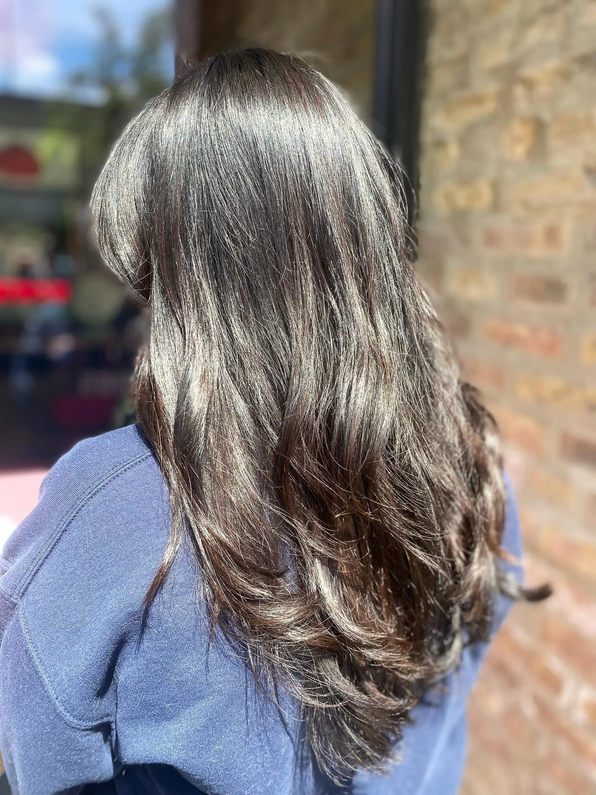 Long layered hair with wavy texture and bangs. 1