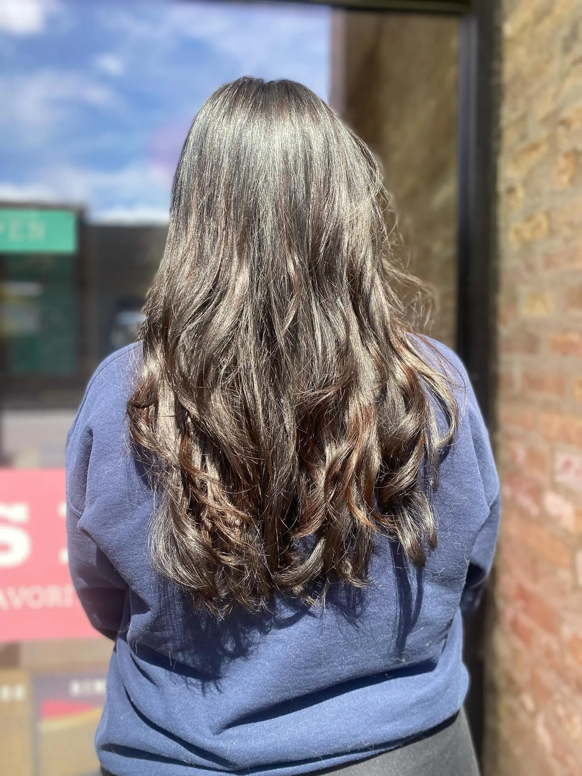 Long layered hair with wavy texture and bangs. 2