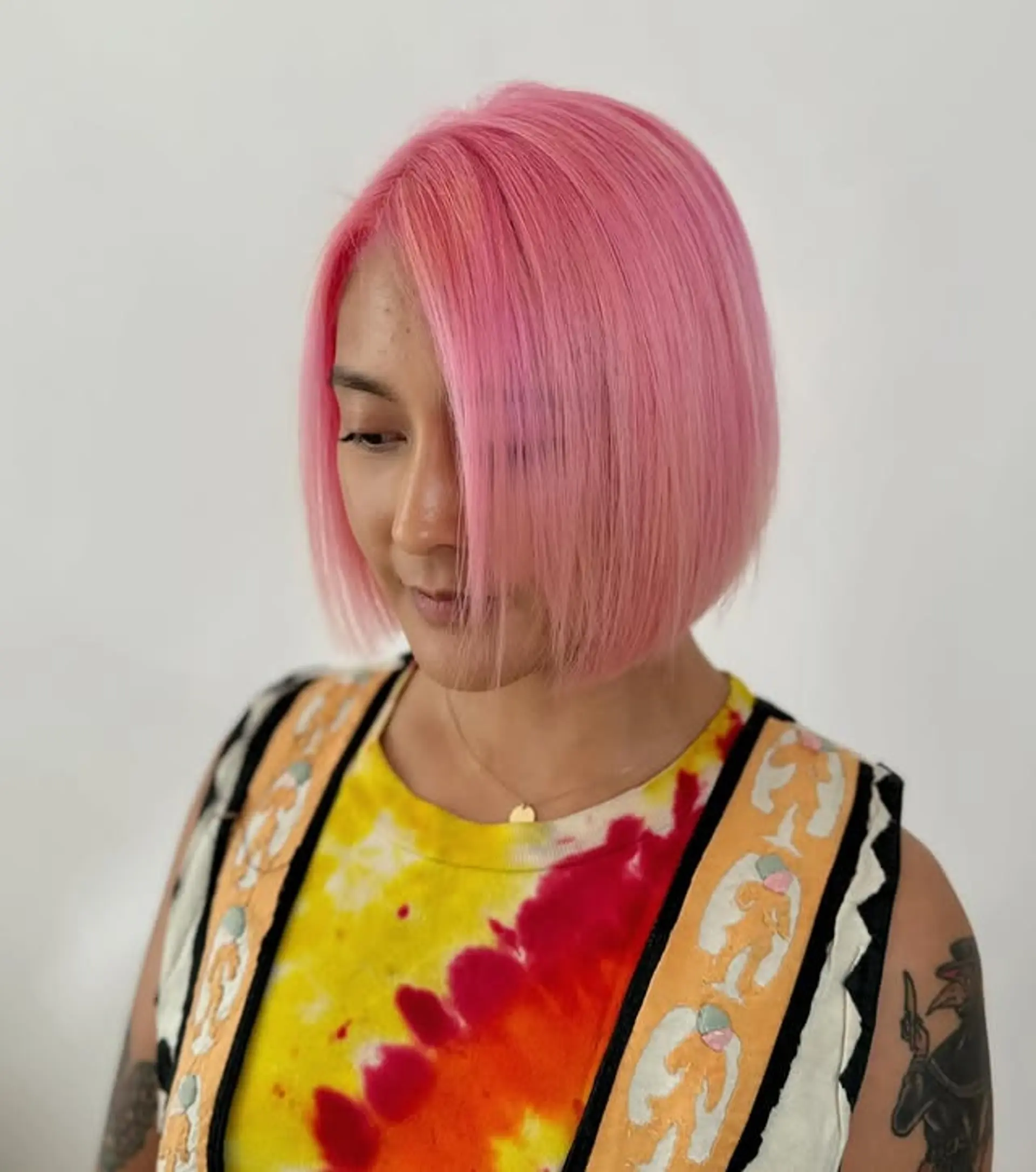 A short, straight bob with a blunt cut and a vibrant pink color. 1
