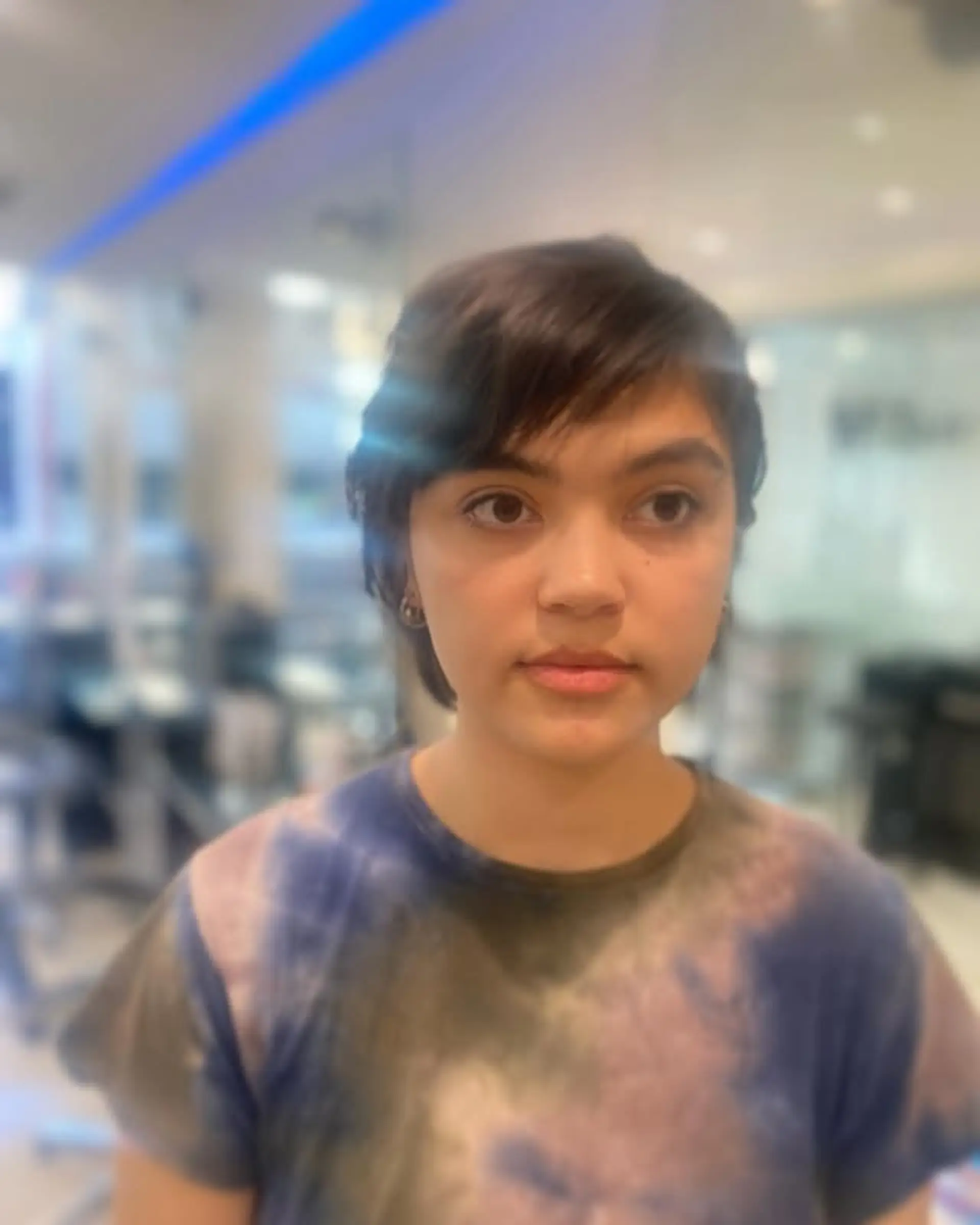 A short, layered pixie cut with textured styling. 1