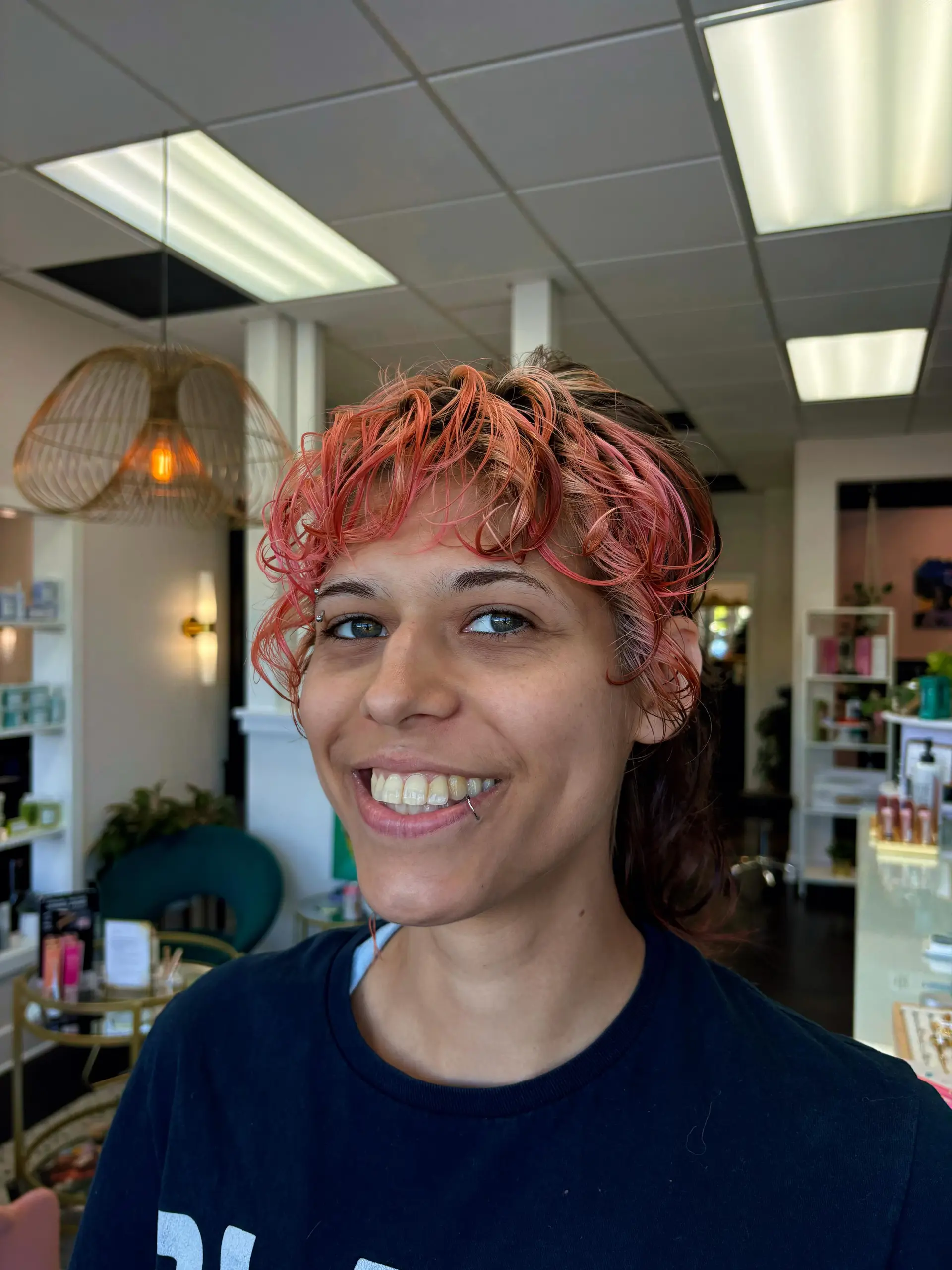 A modern textured mullet cut featuring piecey pink wavy bangs and tight tapered sides. 1