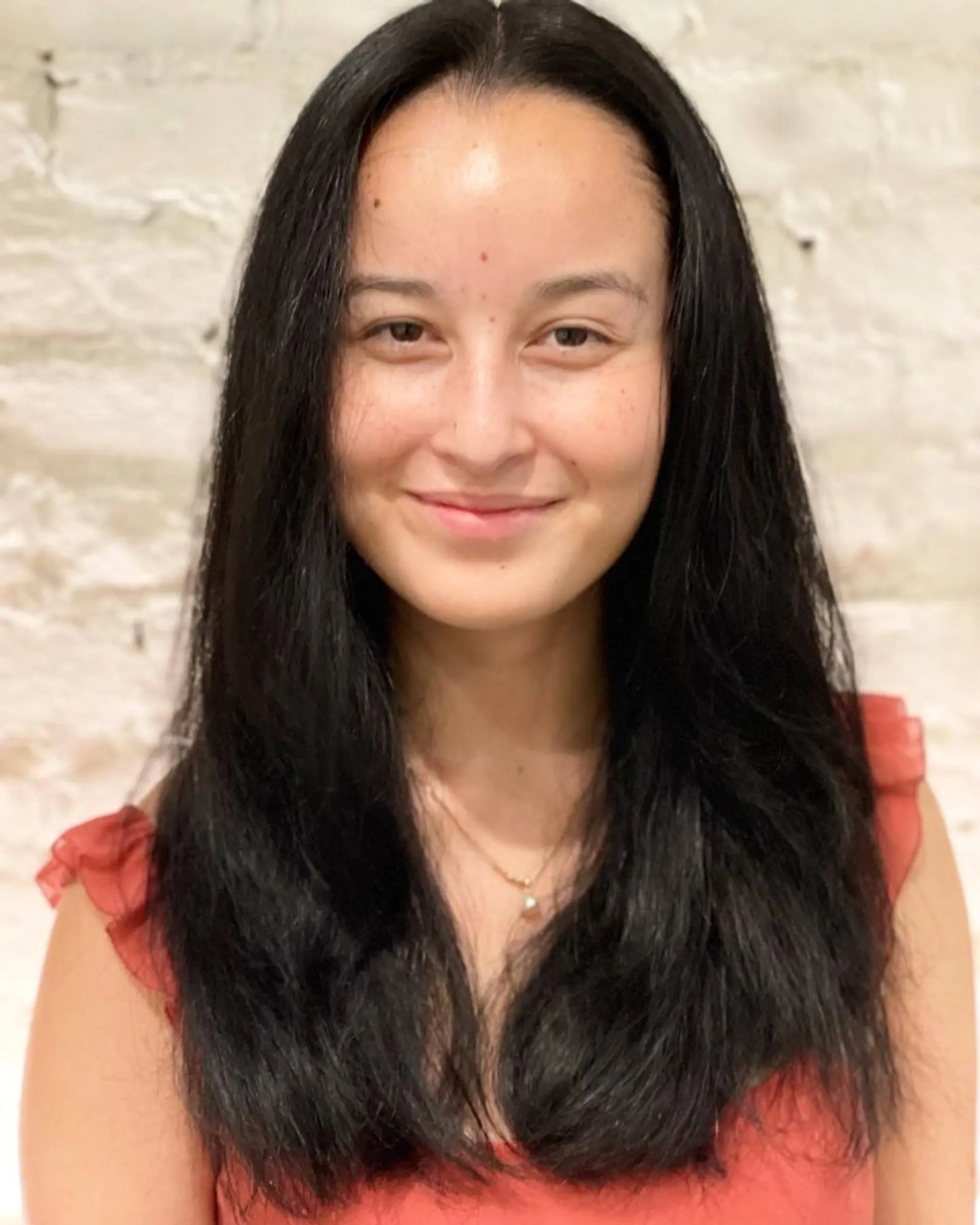 A sleek and straight long hairstyle with subtle layering for added movement and a polished look. 1