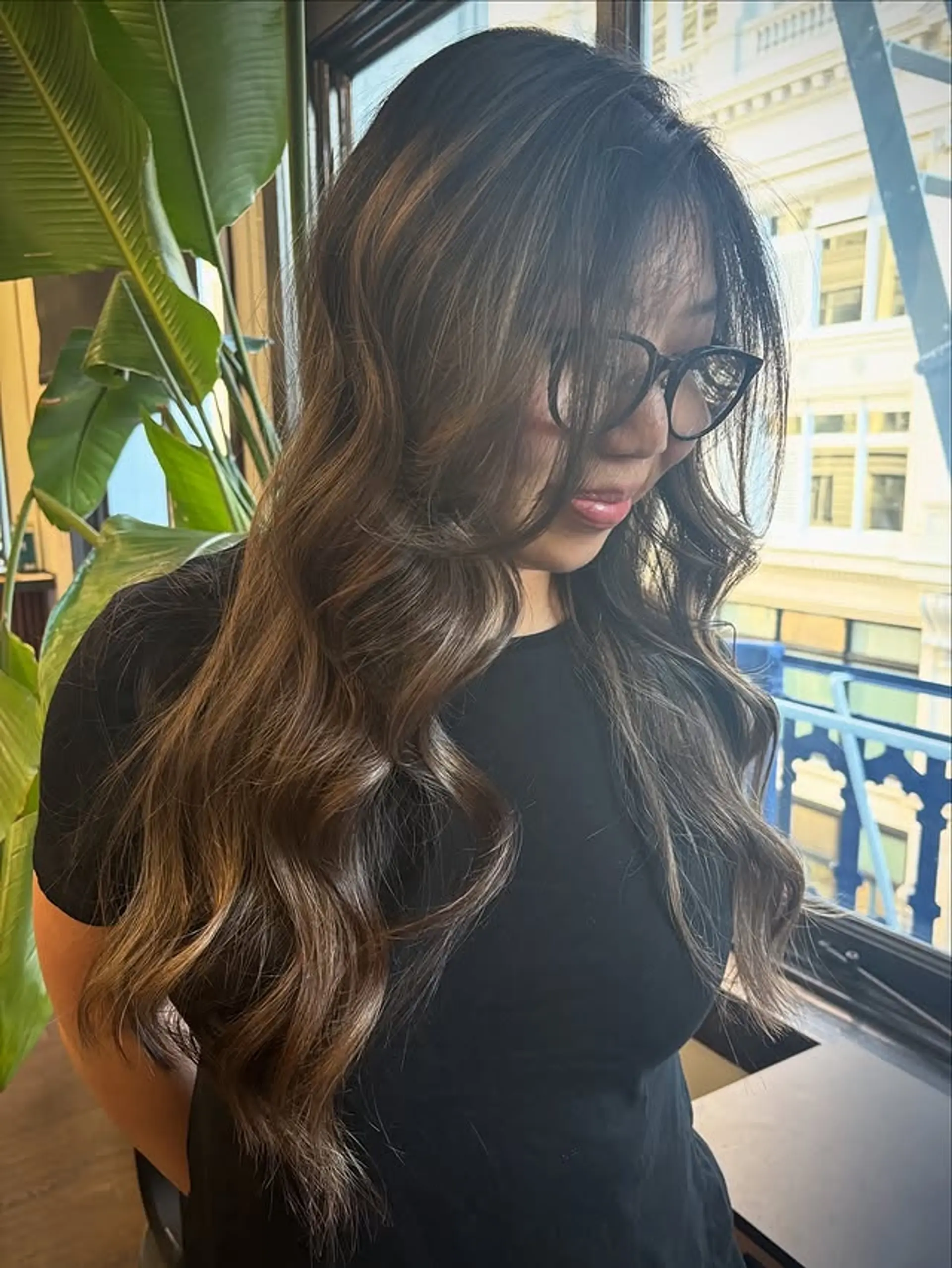 Long, layered hair with soft waves and a dimensional balayage. 1