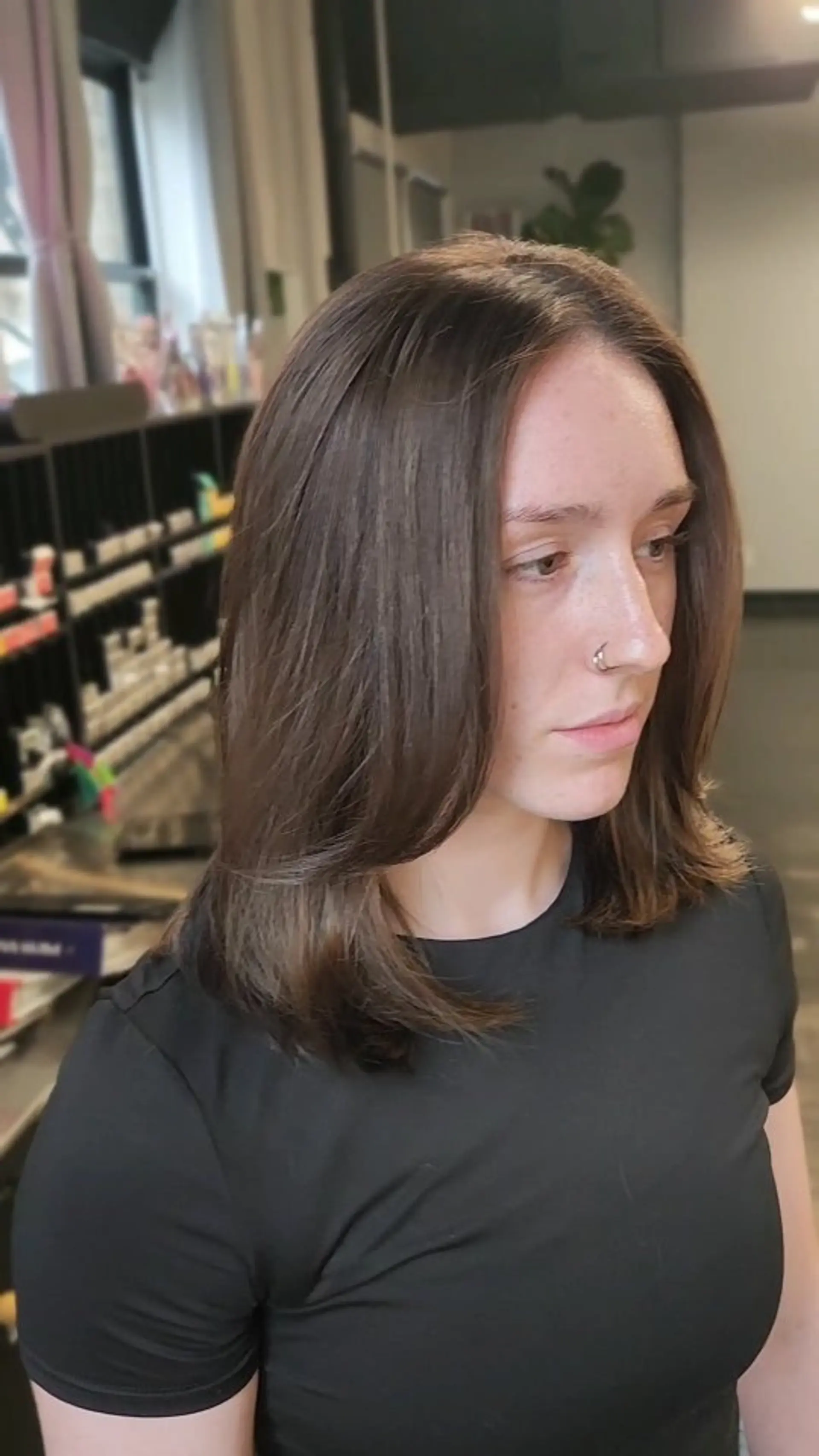 A glossy medium-length brunette hairstyle featuring soft face-framing layers and a smooth, rounded blowout finish. 1