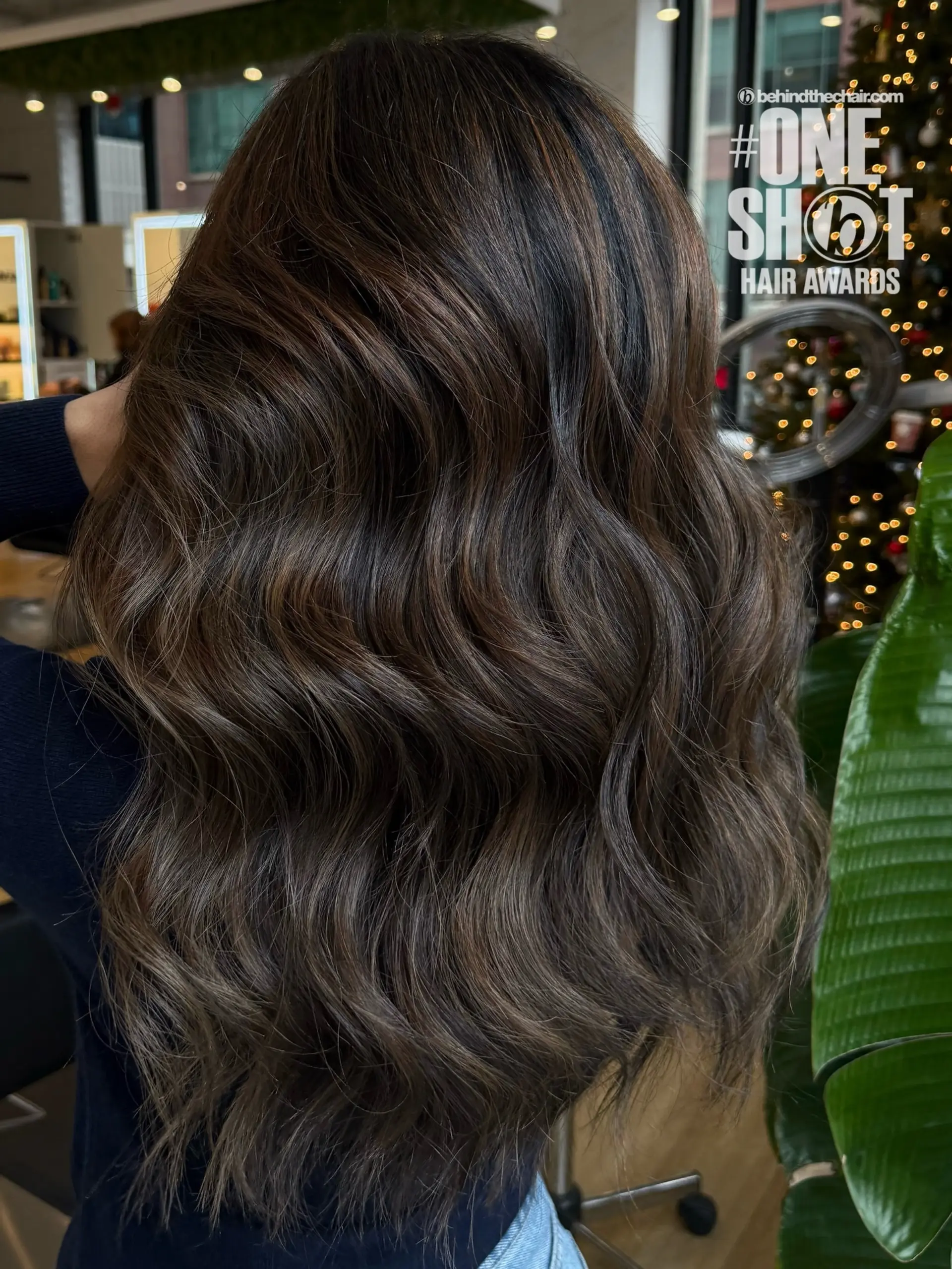 Long dark brown hair styled in soft, glossy waves featuring rich chocolate and subtle dimensional highlights. 1