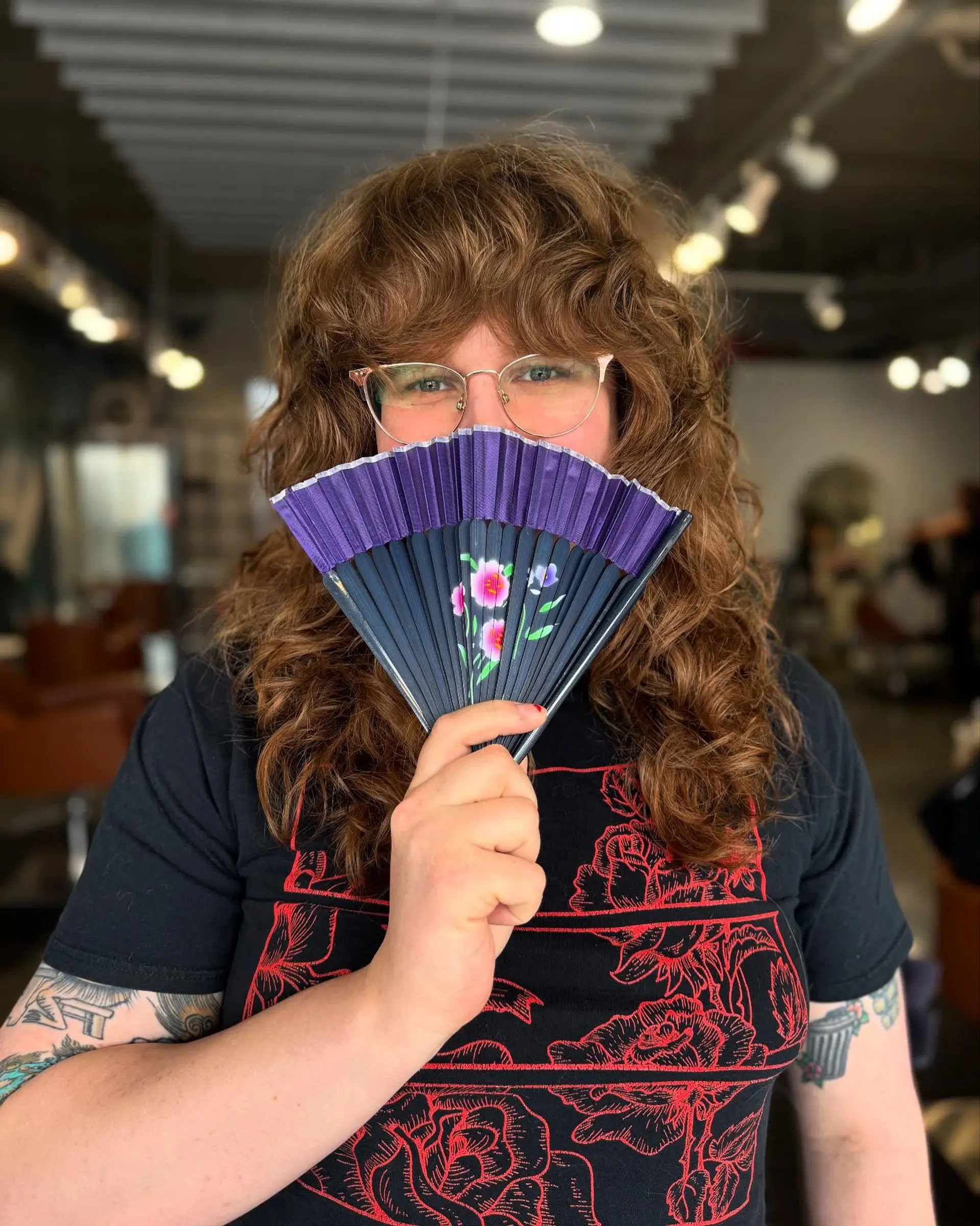 A long, layered shag haircut with a fringe, designed to enhance curly texture and volume. 1