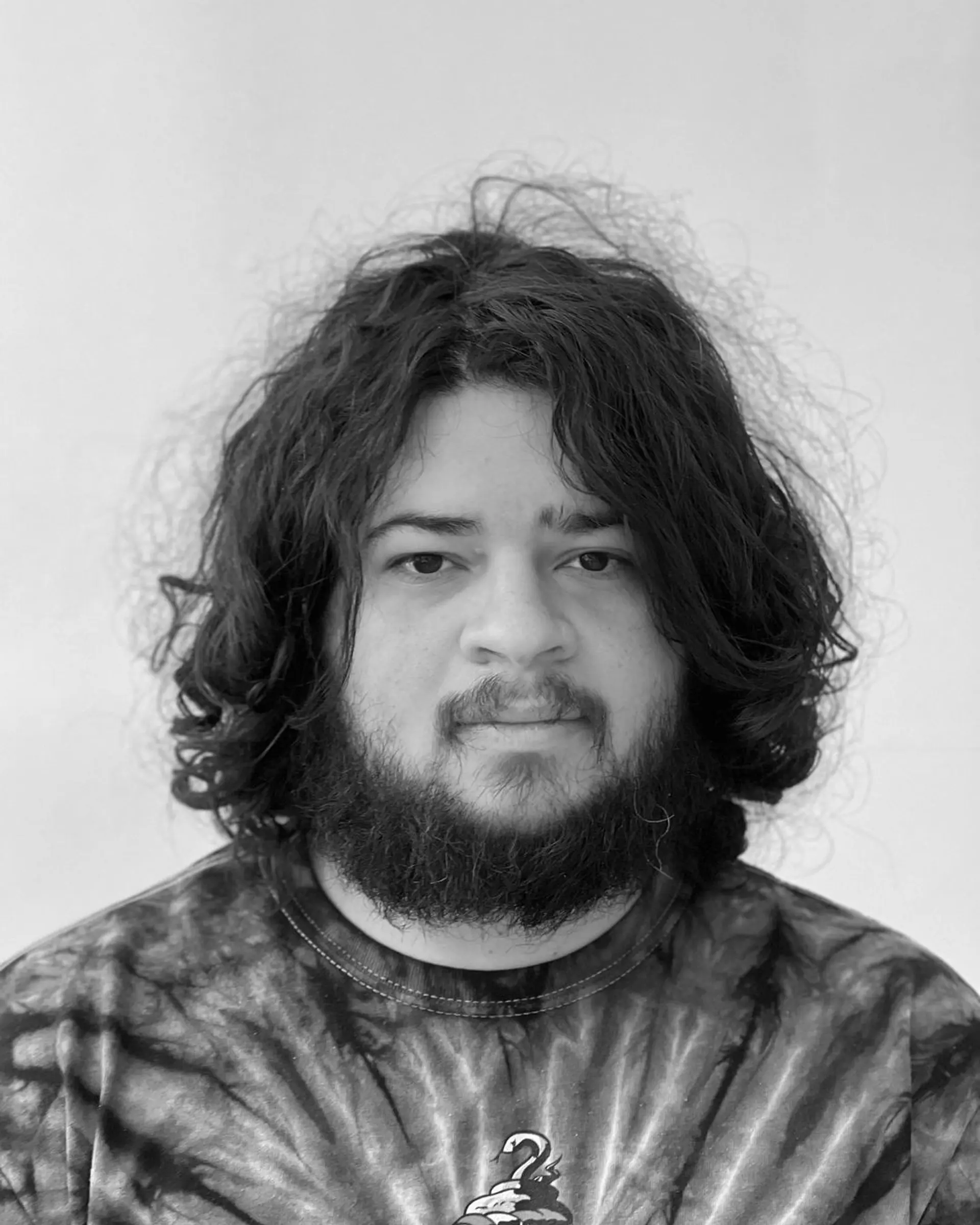 Medium-length, wavy hairstyle with natural volume and texture. The sides are slightly shorter, and the look is complemented by a well-groomed beard.

 3