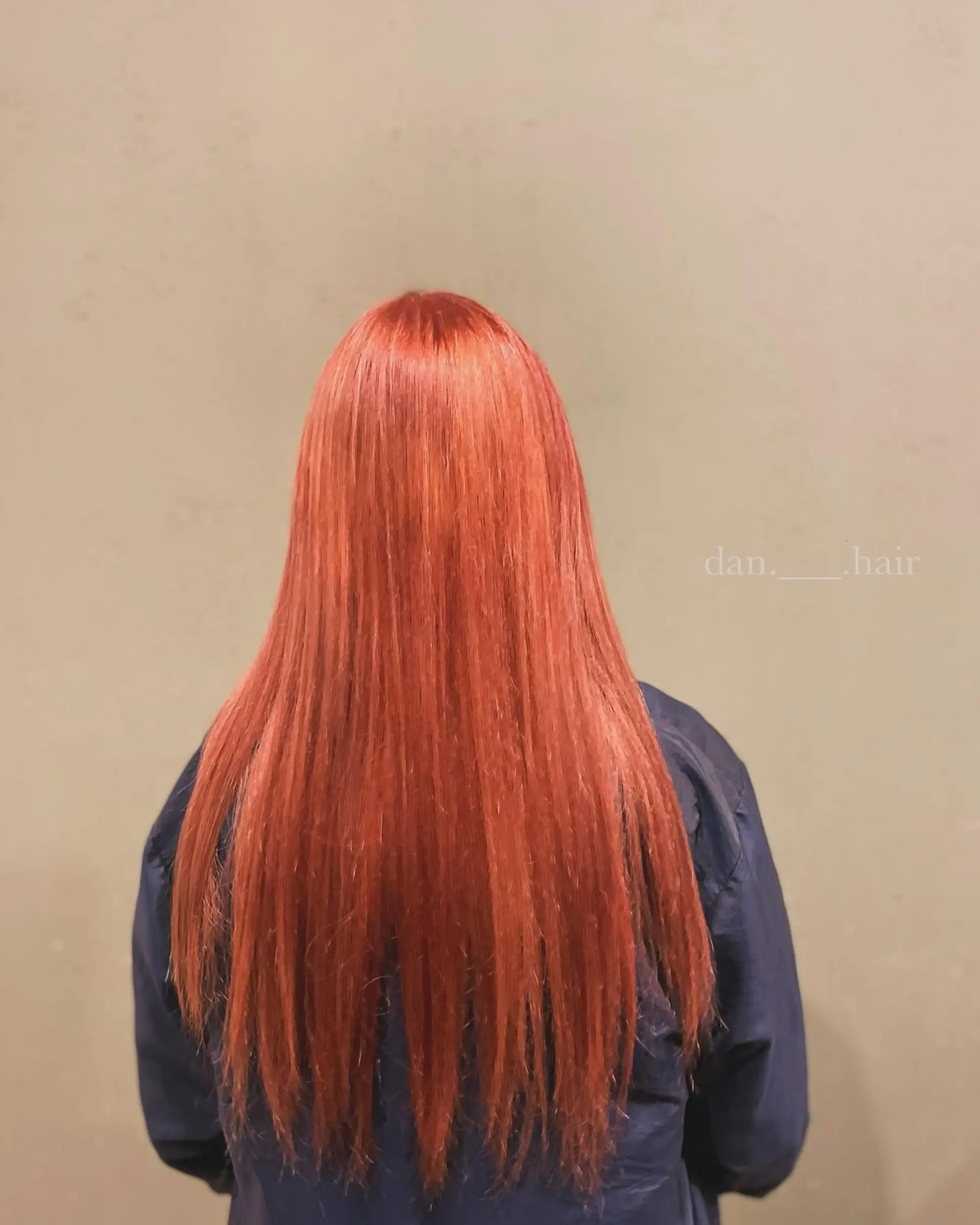 Vibrant, solid fiery orange hair styled straight and reaching mid-back. 1