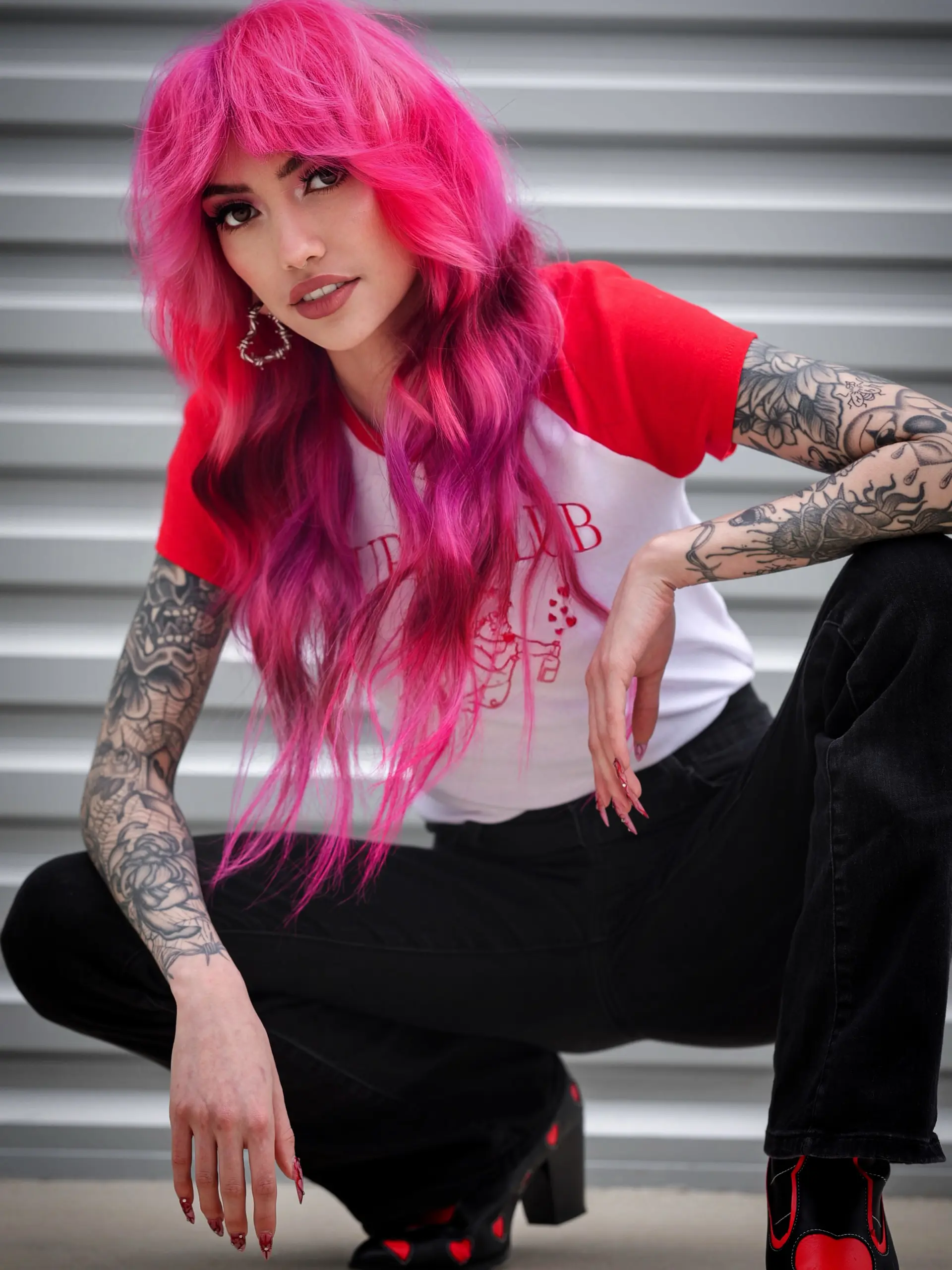 A bold, vivid hot pink shag haircut with full textured bangs and soft, face-framing layers. 1