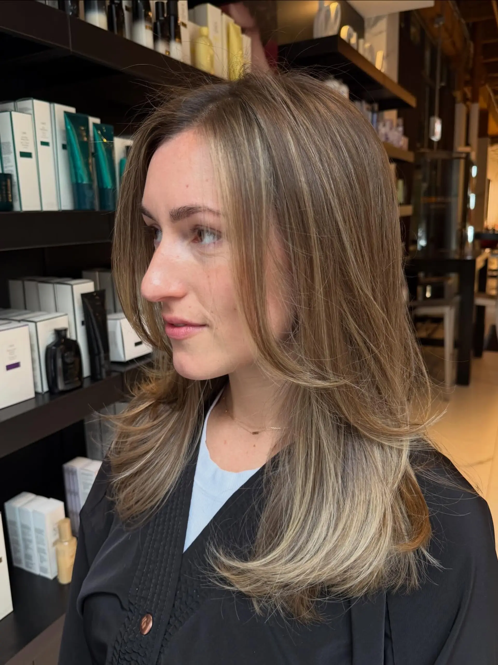 Long layered cut featuring soft face-framing layers and a polished blowout with curved ends, complemented by subtle, dimensional ribbon balayage highlights. 1