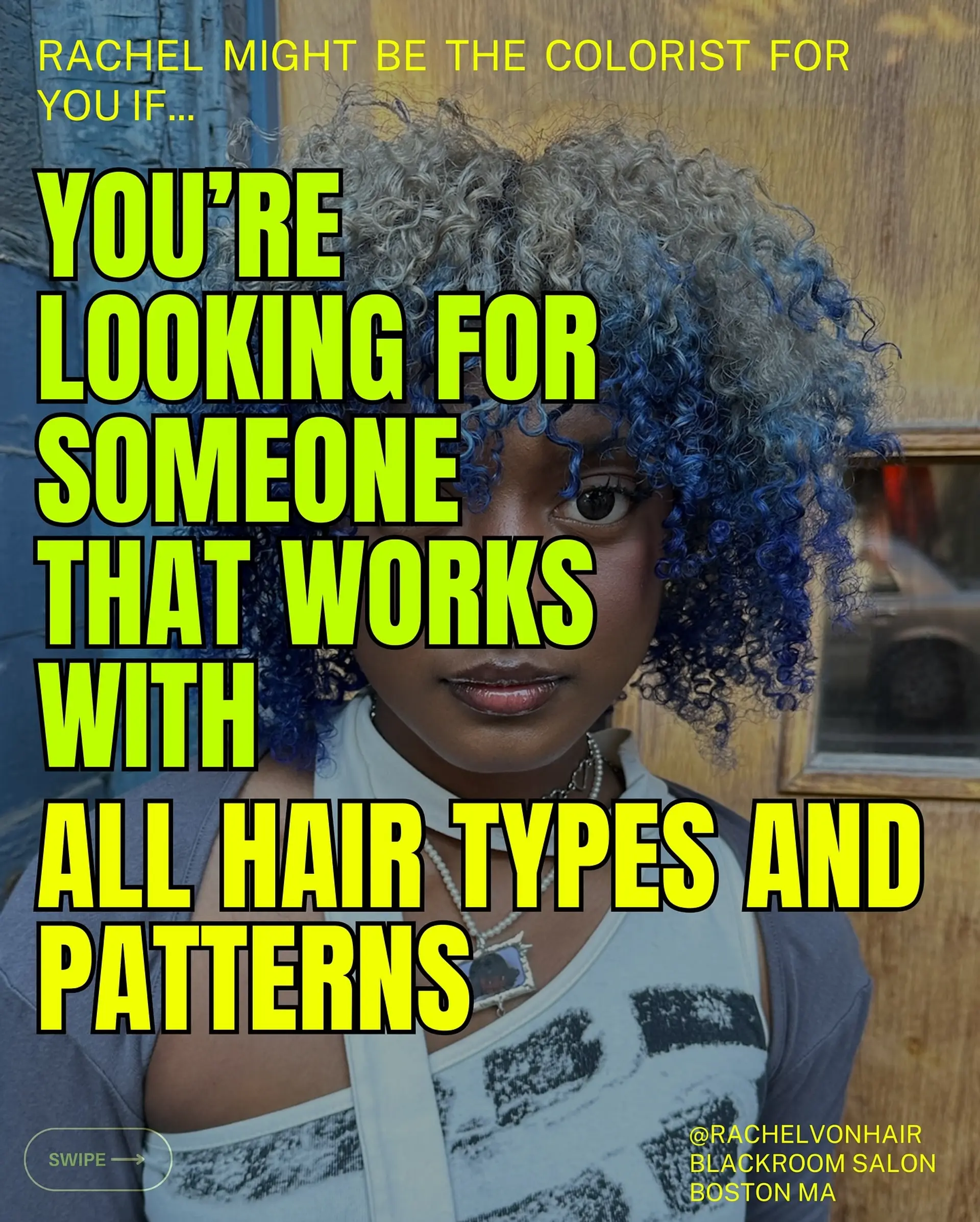 A tight curly short cut with full fringe featuring split-tone or dimensional color of silver-blonde at the crown transitioning into vivid cobalt blue. 1