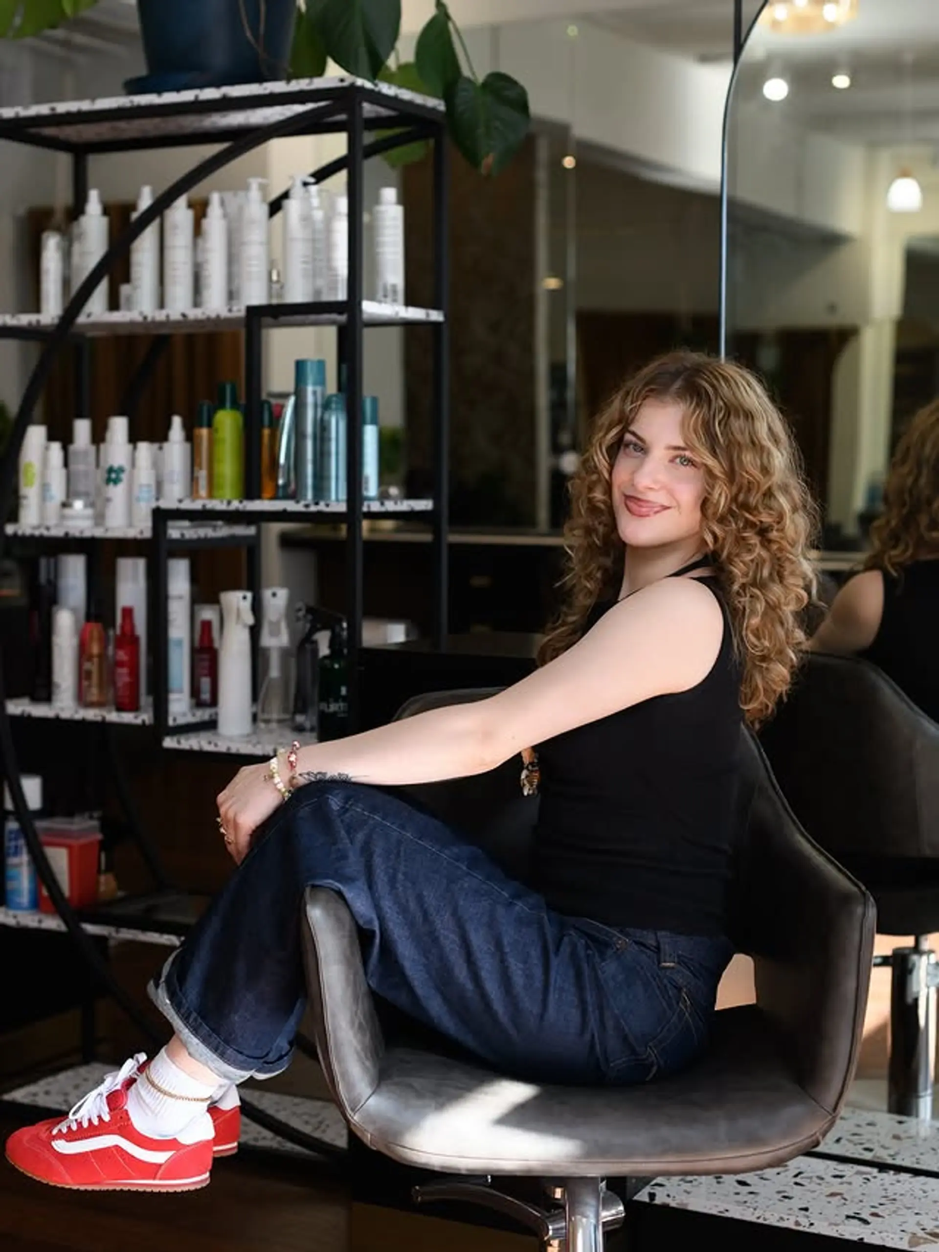 A medium-length curly hairstyle with defined, bouncy curls and a vibrant blonde color. 1