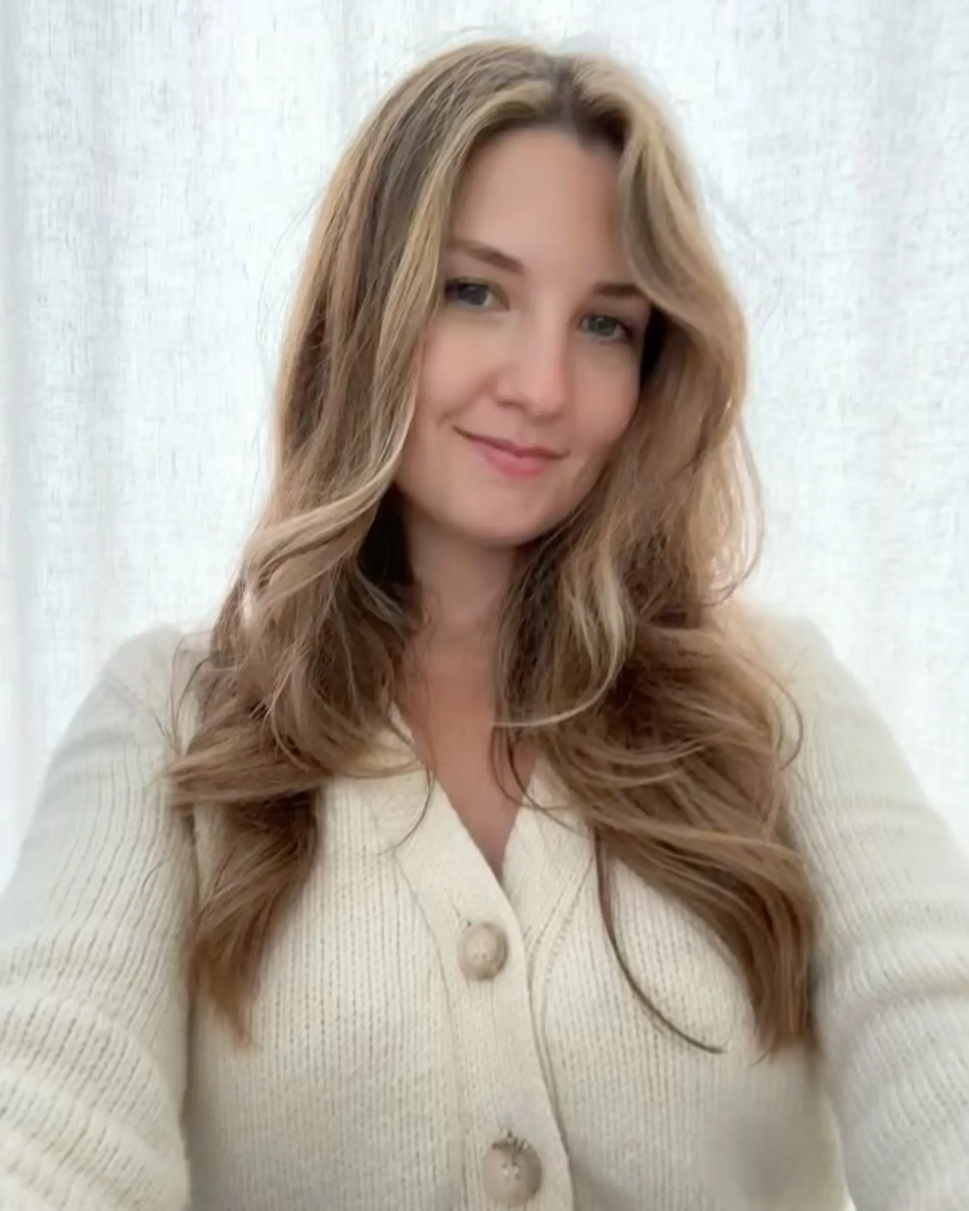 Long hair styled in loose waves with subtle blonde highlights and bright face-framing pieces. 1
