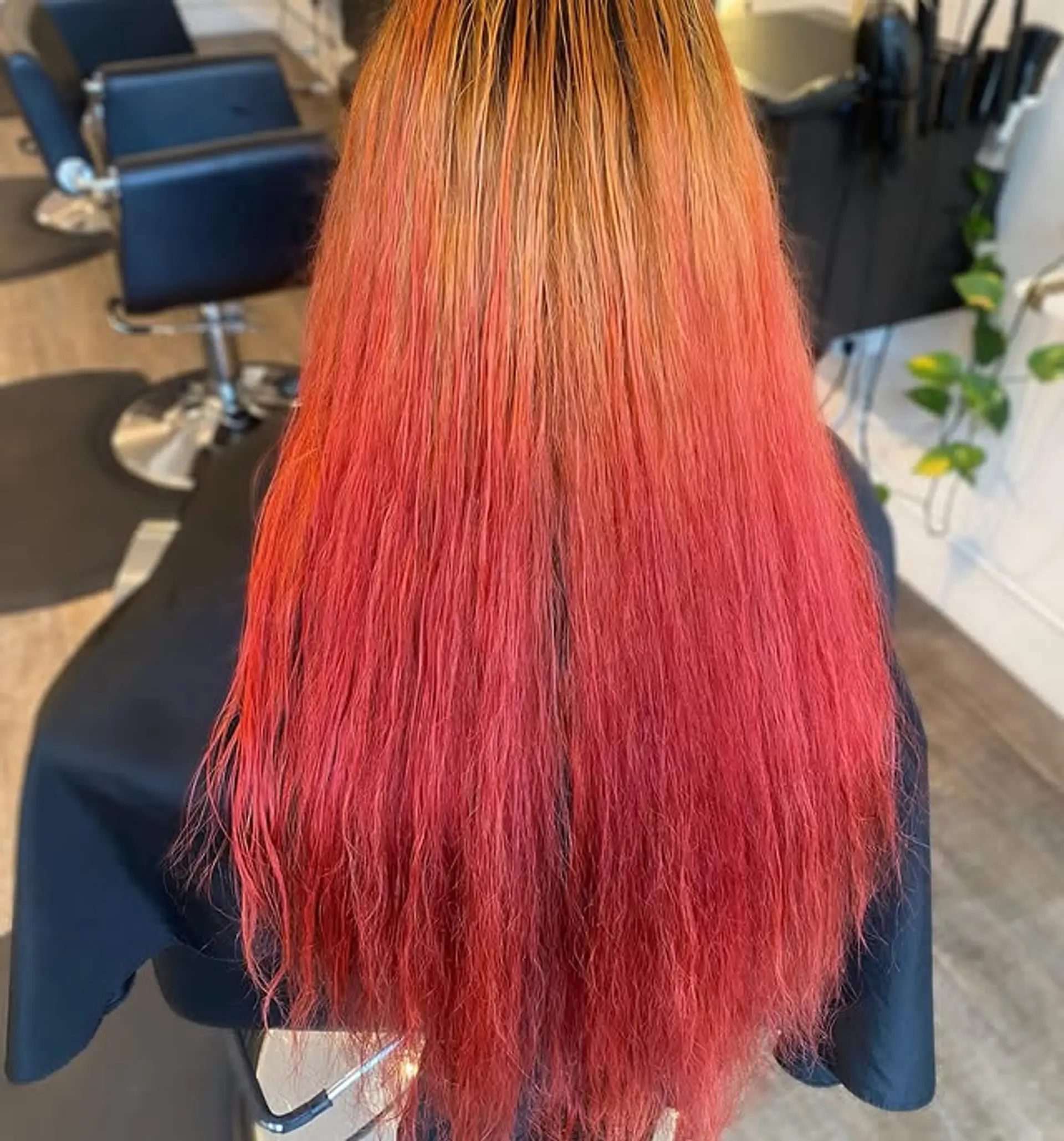 Long, straight hair with a sunset ombre color melt, transitioning from blonde to orange to red. 1