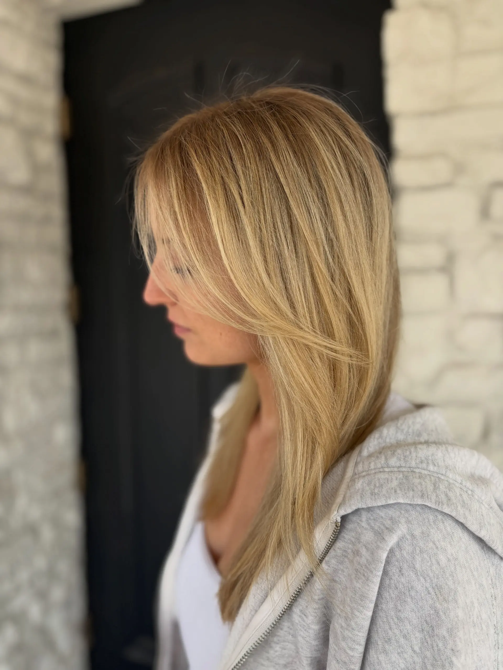 Straight warm golden blonde hair styled smoothly with side-swept, face-framing layers. 1