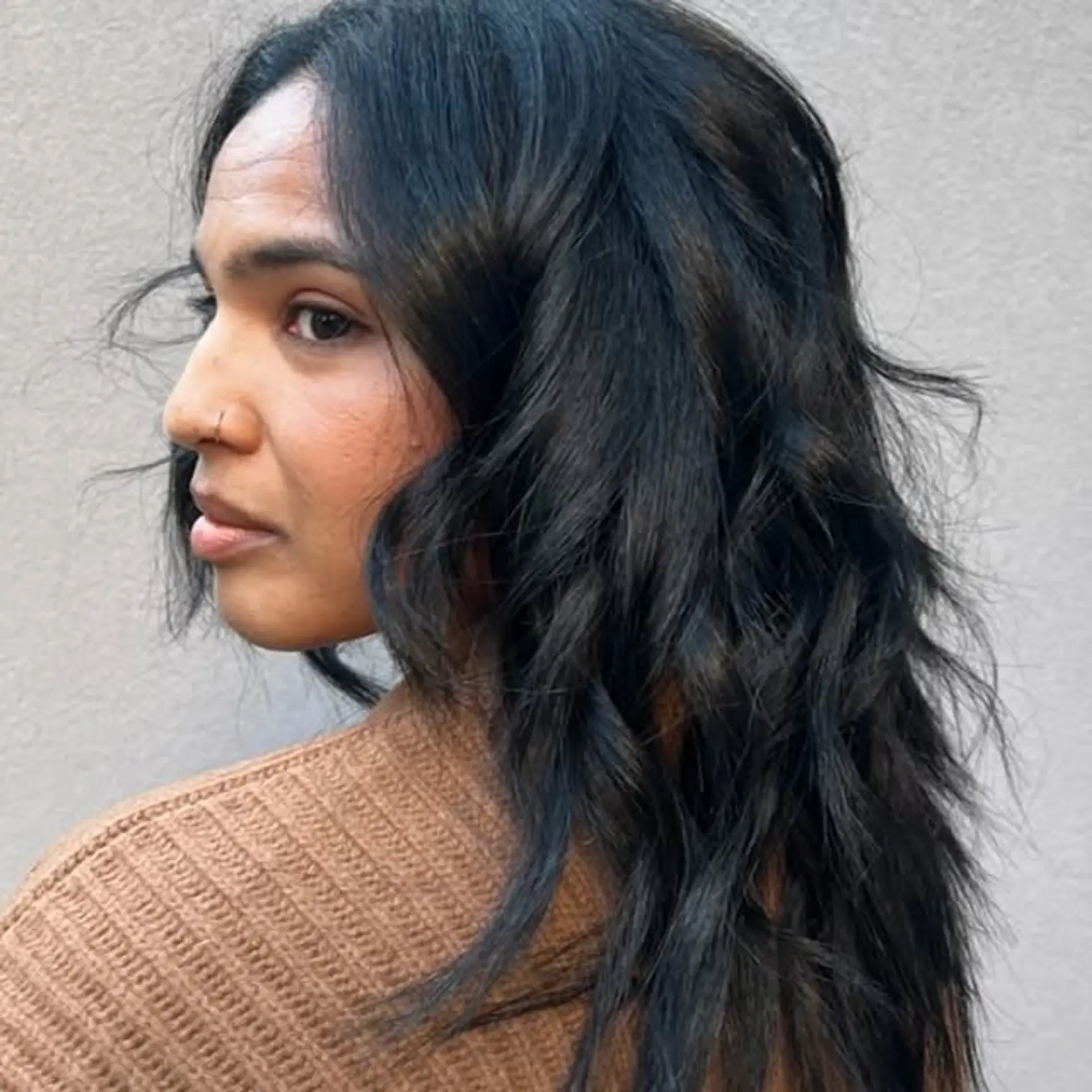A medium-length wavy hairstyle with soft, flowy layers. 1