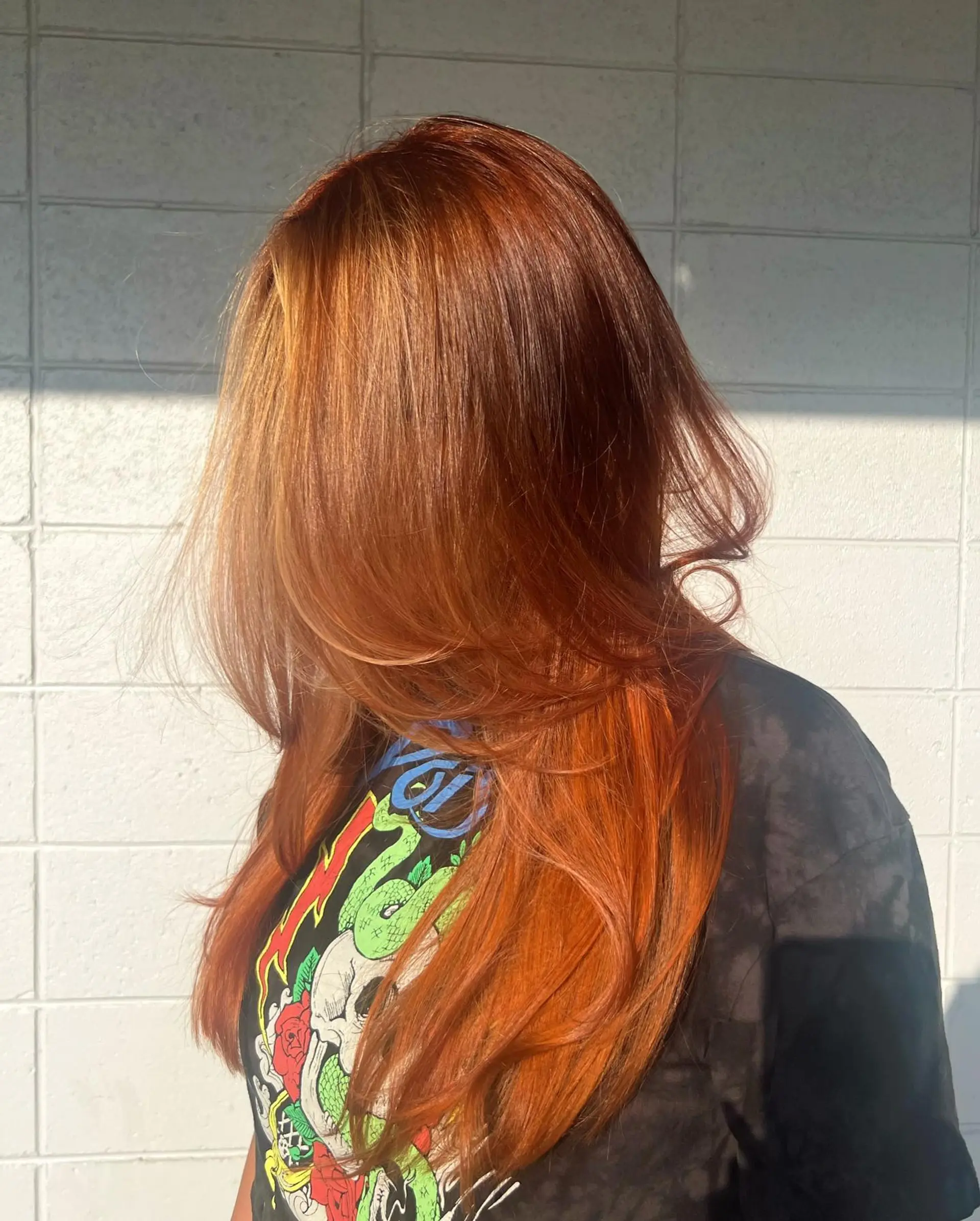 Vibrant copper-red long hair with flowing face-framing layers styled into a smooth, voluminous blowout. 1