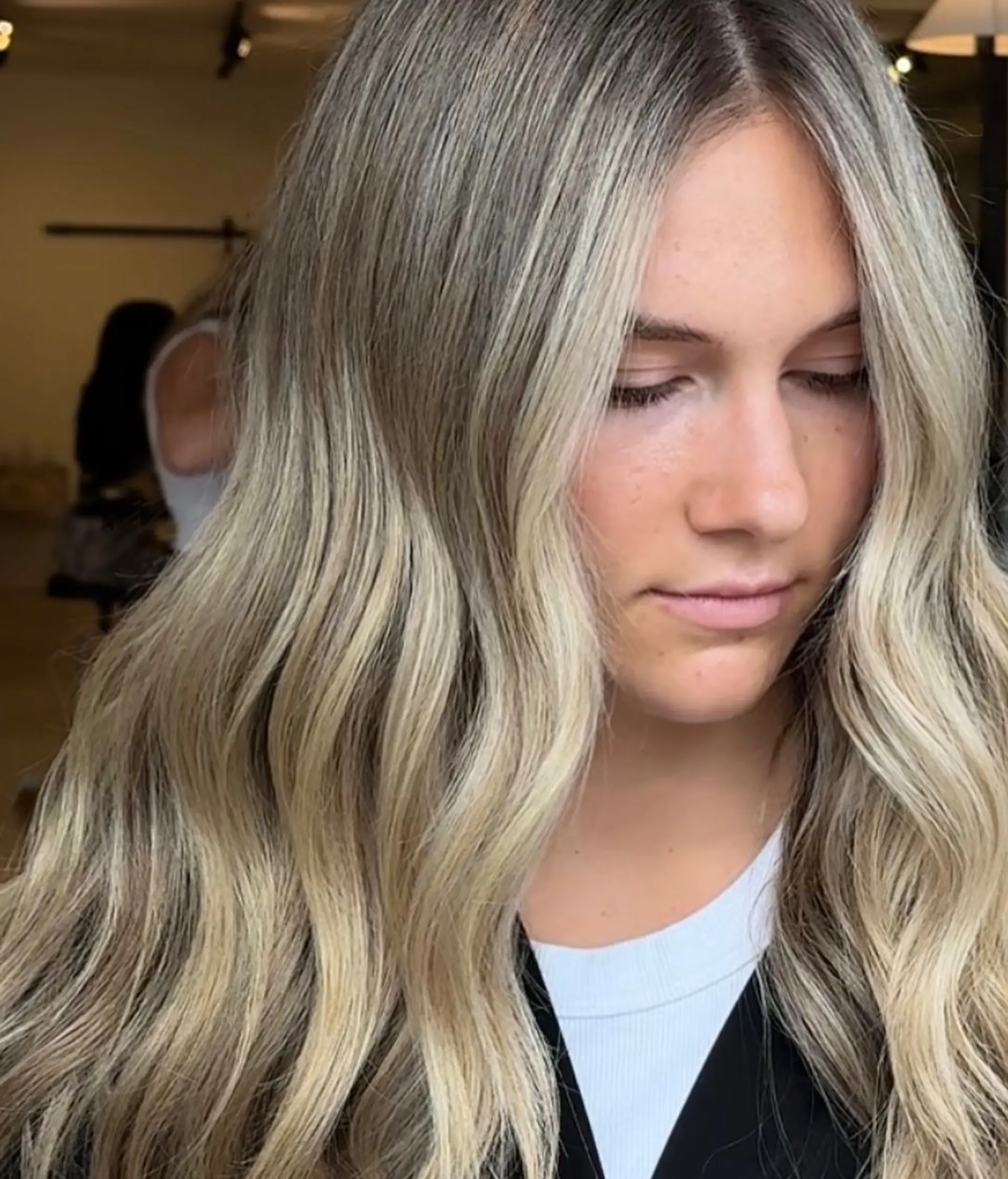 Long dimensional blonde hair styled in soft, flowing waves with bright face-framing ribbons. 1