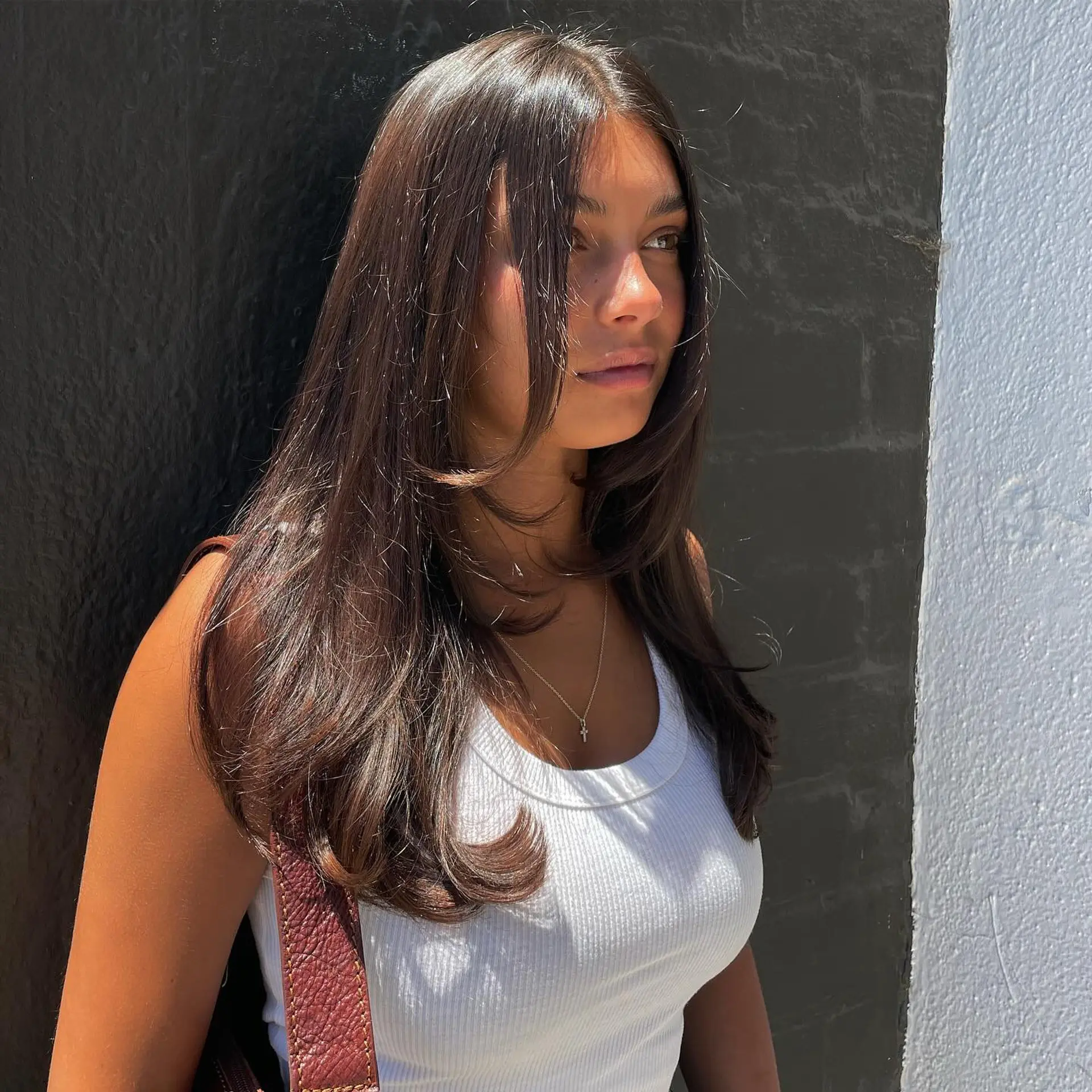 Long, layered haircut with soft face-framing layers. 1